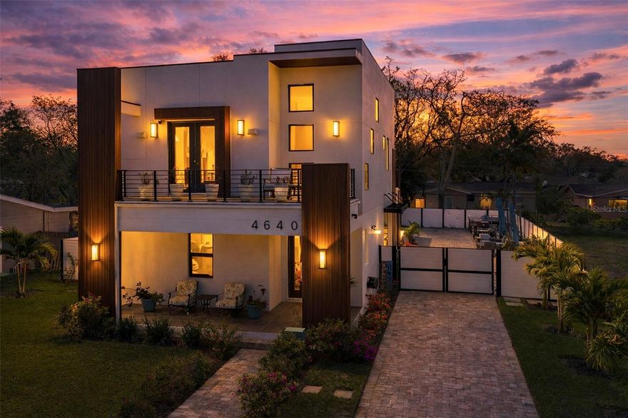 A rare offering where architecture, technology, and lifestyle converge, this extraordinary residence has been thoughtfully designed with every detail carefully considered and every finish intentionally selected. From the moment you arrive, the home tells a story of craftsmanship, comfort, and effortless luxury living.

The main residence features four spacious bedrooms, each with its own private ensuite bath, including a convenient first-floor guest suite, plus a separate powder room. The layout provides exceptional privacy and flexibility, ideal for hosting extended family, accommodating long-term guests, or creating comfortable everyday living spaces.

Adding remarkable versatility is the separate 486-square-foot accessory dwelling unit (ADU) featuring one bedroom, one bath, a full kitchen, and a private balcony overlooking the pool. Perfect as a guest retreat, creative studio, home office, or potential income-producing space, the ADU offers independence while remaining seamlessly connected to the main home.

At the center of it all is a beautifully designed chef’s kitchen, where form meets function. Floor-to-ceiling custom cabinetry in a rich charcoal finish, accented by brass hardware, provides abundant storage alongside a generous walk-in pantry. A striking quartzite-topped island with seating anchors the space beneath designer lighting, while premium Dacor appliances—including a convection wall oven, microwave, induction cooktop with pot filler, warming drawer, dishwasher, and refrigerator with dual ice and filtered water—create a kitchen built for both everyday living and elegant entertaining.

Outdoor living is equally extraordinary. The screened outdoor lounge with hibachi grill kitchenette offers a peaceful retreat for morning coffee or evening aperitifs, while the expansive backyard transforms the property into a true entertainer’s paradise. The heated pool and spa create a resort-like atmosphere complemented by an outdoor kitchen with Big Green Egg, gas grill and burners, outdoor refrigerator, pool half bath, and outdoor shower—ideal for hosting unforgettable gatherings under the Florida sky.

Enhancing the experience throughout the home is a professionally integrated high-end audio system, with 7.1 surround sound in the family room, dedicated systems in both primary suites, and six outdoor speakers with subwoofer throughout the backyard, allowing music to flow seamlessly from indoors to out.

Technology and security are equally impressive, including a comprehensive Montavue camera system with 11 exterior and four interior cameras, while all audio, visual, and internet components are professionally organized within the home’s centralized technology hub.

Additional upgrades include automated window treatments compatible with Google Home and Alexa, Culligan whole-house water softener and filtration system, California Closets throughout the main home, an electric fireplace, vegetable garden, and an array of fruit trees including grapefruit, plum, cherry, papaya, and lychee.

This remarkable property represents modern luxury living at its finest, where thoughtful design, state-of-the-art technology, and exceptional indoor-outdoor living come together to create a home that is both stunning and unforgettable.