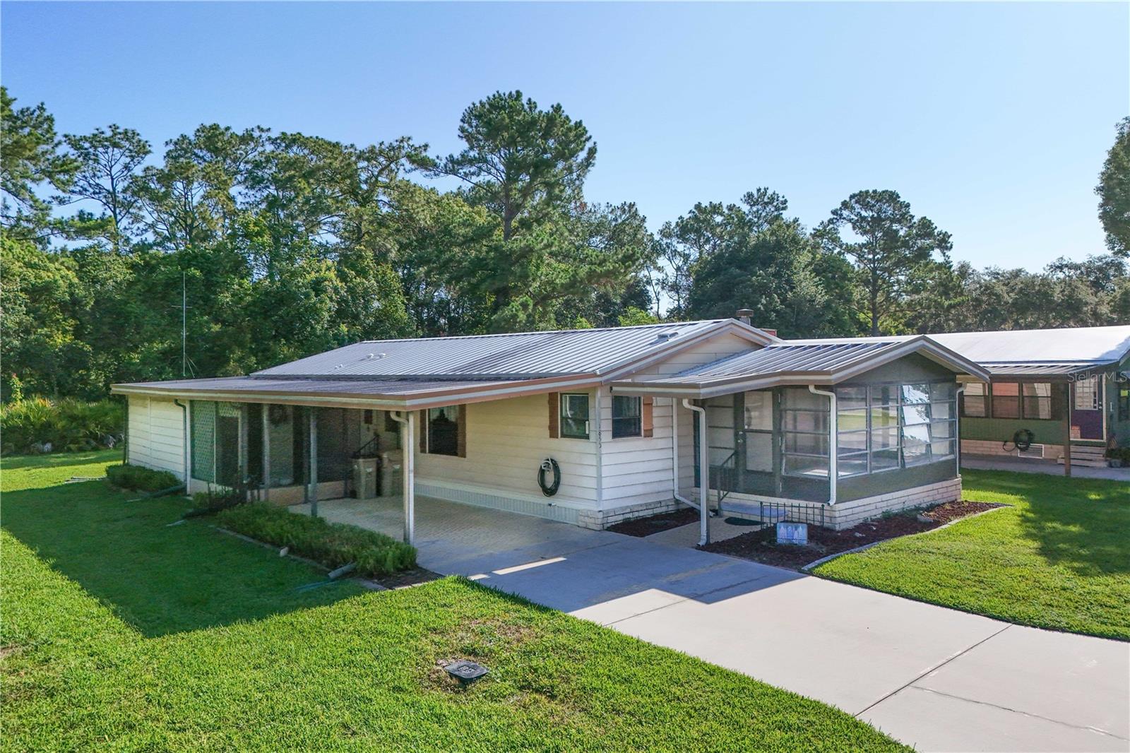 Conveniently located in an active 55+ community known as Dora Pines in the beautiful, quaint town of Mount Dora. You own the land, and the HOA is a low $60 a month. This Lovely 2 bedroom, 2 bath home is move-in ready and has a very private lot with woods to the rear and city property to the west. This home offers plenty of space with large room sizes, both bedrooms have walk-in closets, there is a separate office, as well as plenty of outdoor space including a glass enclosed porch, a screen porch, a deck overlooking the nature and wildlife to the rear, and a large utility room/workshop. The home has newer vinyl plank flooring, and HVAC was replaced in 2022. The Dora Pines community offers amenities such as a Hospitality house, pool and pavilion, shuffleboard courts, a pond (catch and release fishing permitted), a park and clubhouse with many community activities. Whether you live in Florida full time or are looking for a Snowbird retreat this home and community has it all. Orlando and Sanford airports, as well as Disney are all about 30 miles away, so you can enjoy the convenience when family and friends visit. Both coasts are only about 90 minutes away as well. Don't let this gem pass you by.