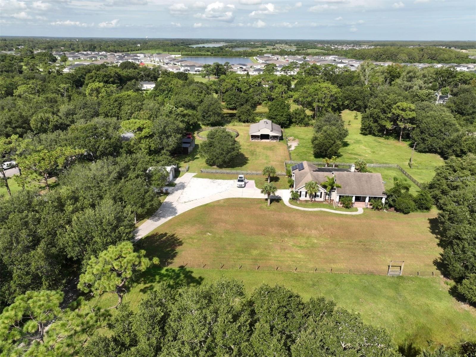 Stunning Florida Ranch Home on Almost 5 Acres Welcome to your dream ranch home in St. Cloud of Florida! This beautifully renovated property offers a perfect blend of modern comfort and serene country living, ideal for those seeking tranquility, privacy, and endless green views. With 1,932 square feet of heated living space, this home is designed for both relaxation and entertainment. Key Features: Great Floor Split Plan: Enjoy the privacy of a split floor plan with 3 bedrooms and 2 bath, perfect for families or guests. Front Patio: Relax on rocking chairs at the front patio and take in the beautiful landscaping that surrounds your new home. Covered Back Patio: Host the best BBQ pool parties on the covered back patio, which overlooks a sparkling pool. Modern Kitchen: The kitchen boasts all stainless steel appliances ,upgrade cabinets and elegant marble countertops, making it a chef’s delight. Charming Living Room: Cozy up to the real stone fireplace in the living room, featuring trendy waterproof laminate flooring throughout the living area. Outdoor Oasis: The almost 5-acre fenced farm includes a pool, horse stable, solar panels, storage space, and a picturesque little pond. Beautiful Scenery: Enjoy endless green views and the tranquility of southern living with well-maintained grounds. Newly Renovated: This home is move-in ready with recent renovations that add modern touches while maintaining its rustic charm. Great Privacy: Experience unparalleled privacy in this secluded paradise, perfect for those who value peace and quiet. Additional Features: Horse Stable: Ideal for equestrian enthusiasts, the property includes a horse stable for your beloved animals. Solar Panels: Energy-efficient paid off solar panels help reduce your carbon footprint and utility bills. Storage: Ample storage space for all your needs. Pond: A lovely pond adds to the charm and natural beauty of the property. Fence: endless wood and wire fence all over the property. This Florida ranch home is more than just a place to live; it's a lifestyle. Don't miss out on the opportunity to own a piece of paradise. Schedule a viewing today and start living the life you've always dreamed of. Welcome Home.