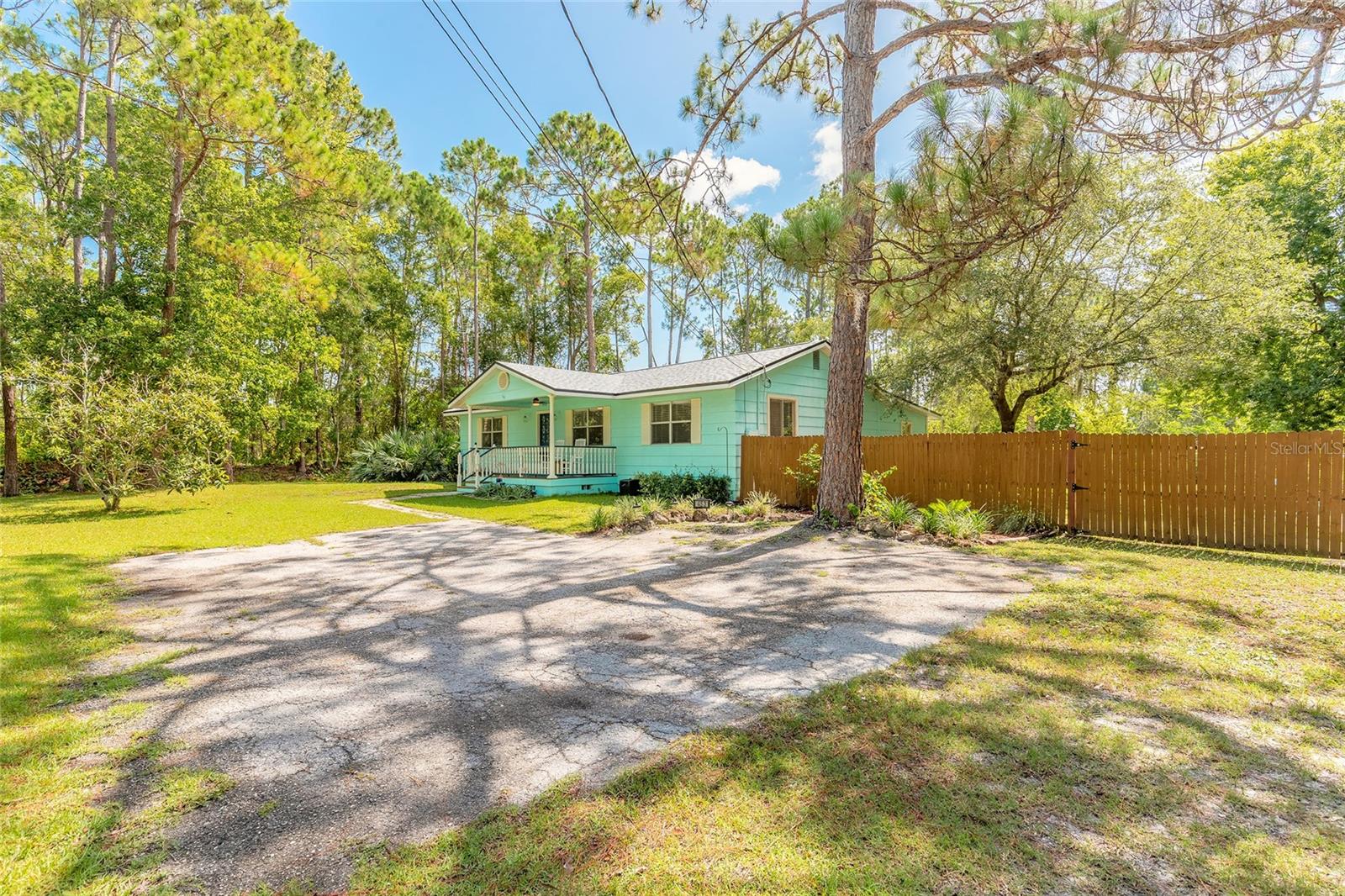 Welcome to your private retreat in Deltona! Tucked away in a peaceful and secluded area, this charming 3-bedroom, 2-bathroom home is perfectly situated on a spacious double lot, offering ample room to bring your toys, boats, RVs, or create your dream outdoor oasis. From the moment you arrive, you'll be greeted by inviting curb appeal and a delightful front porch, an ideal spot to sip your morning coffee or unwind in the evening. Step inside to discover a well-designed split floor plan that maximizes privacy and functionality. Beautiful vinyl flooring flows throughout the home, offering both durability and style. The kitchen is a standout feature, boasting updated appliances, real wood cabinetry, and abundant storage space to meet all your culinary needs. Just off the kitchen, step down into a versatile bonus room under air, perfect for a home office, gym, or playroom. This space also includes a laundry area with washer and dryer, all conveniently climate-controlled, and provides direct access to the expansive backyard. The master bedroom offers a peaceful escape with a generously sized en-suite bathroom, while the two guest bedrooms are spacious and comfortable, ideal for family or visitors. With no rear neighbors and nestled in a quiet area, this home delivers the perfect combination of privacy, comfort, and versatility. Whether you're seeking space to grow, entertain, or simply enjoy the outdoors, this rare opportunity in Deltona checks all the boxes. Don't miss your chance to own this unique property with room to roam! Roof 2024.