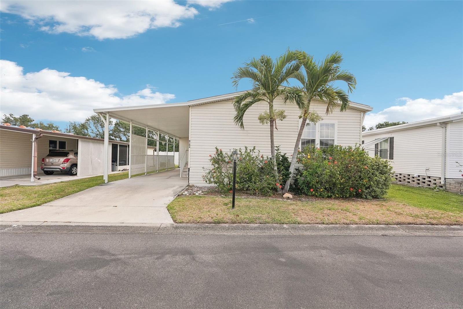 Welcome to Westwinds Village, a charming 55+ age-qualified cooperative community in Bradenton, Florida. This is NOT LOT RENT, and the sales price includes a share in the community! This community has a great location on US-70, with quick access to the Gulf beaches, or to I-75. There are two entrances to the community, and there is a traffic light available as well for less stress! This home is located in one of the quietest corners of the park, with quick access to the community pool and side entrance. There is really only one word for this home - WOW! The sellers of this home were the original owners, and did not skimp on upgrades! When you enter the home, you will walk right into the open living space, with the kitchen, living room, and dining area flowing into one room. The walls and ceilings are drywall, with recessed lighting and a kitchen island. Off the kitchen is a laundry room with plenty of storage space. One of the coolest features of the kitchen is a massive walk-in pantry that is hidden behind a cabinet facade; an absolute dream for your grandkids who love to play hide and seek! The master suite is located at the back of the home, with a large walk-in closet, ensuite bathroom with garden tub as well as separate shower stall, and there’s also a private back patio, complete with screens, perfect for relaxing! The other two bedrooms are a good size, one of which is currently set up as a home office. The second bathroom features a shower / tub combo. There is a huge storage room in the carport area as well. The home is being sold furnished as seen in the photos. Westwinds is one of the most amenity-rich communities in the area. Some of the amenities include: pool, clubhouse, shuffleboard, billiards, library, and lawn bowling!