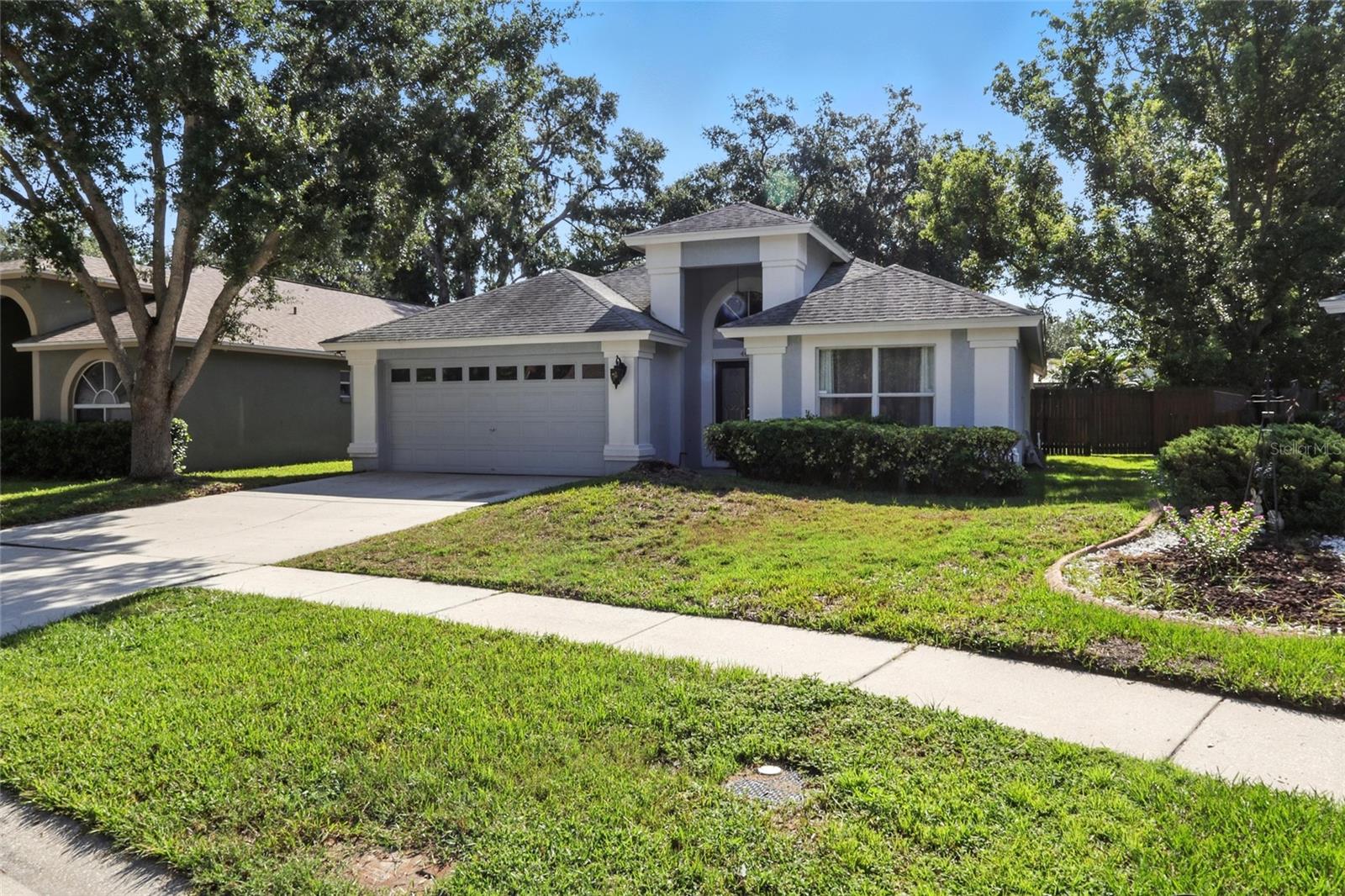 Welcome to this beautifully maintained 3 bedroom, 2 bathroom home located in the Preston Woods neighborhood of Bloomingdale in Valrico! Step through the grand French door entry into a bright, open interior featuring elegant Brazilian hardwood flooring in the main living areas and durable tile in all wet areas. Soaring ceilings and a thoughtfully designed open floor plan create an airy, spacious atmosphere. At the front of the home, you’ll find formal living and dining rooms, ideal for hosting guests. Toward the back, the well-appointed kitchen offers stainless steel appliances, ample cabinet and counter space, and a closet pantry. The kitchen overlooks the spacious family room with a wall-sized sliding glass door that leads to the covered back patio. Each bedroom offers generous living space, and the primary suite is a peaceful retreat featuring its own private sliding door to the patio, a walk-in closet, and an en suite bath complete with dual sinks and a walk-in shower. Out back, enjoy your private yard with a covered patio, perfect for relaxing or firing up the BBQ. Living in Preston Woods means access to private and public parks, basketball and tennis courts, racquetball courts, and playgrounds, all within a well-established community. Plus, you’re just minutes from great shopping, dining, and a short commute to downtown Tampa. Don’t miss your chance to own this beautiful home! Schedule your showing today!