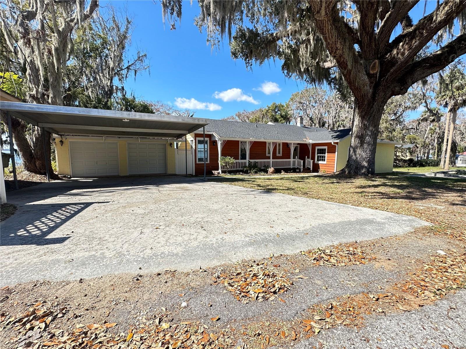 Welcome to this charming 3-bedroom, 2-bathroom house for sale at 30437 Orange Drive Leesburg, Florida. This lovely property offers an open and inviting living space with a range of desirable features.
As you step inside, you're greeted by beautiful hardwood floors that add warmth and character to the living area and bedrooms throughout the home. To the left, there is one bedroom and a full bathroom. To the right, the master suite, full bathroom, and an additional bedroom. Throughout the home each room is illuminated with natural light.
Large windows provide stunning lake views in the living areas. Whether you're relaxing in the spacious living room, enjoying a meal in the dining area, or cooking a meal in the kitchen you'll have the pleasure of gazing out at the waters of Lake Harris. This home has been completely remodeled, boasting a fresh and modern look with a brand new kitchen, light fixtures, and renovated bathrooms.
For those who love outdoor activities, this property offers a dock where you can spend leisurely days by the water fishing and soaking up the sun. This dock is not fit for housing boats, and there is no space for large boats on the property.
With ample parking spaces for up to 4 vehicles, a double garage and carport, convenience is never compromised. Additionally, a garage for storage is located behind the home.
Additionally, situated very close to the water, is a delightful 1 bedroom 1 bathroom cottage, with a small living area and kitchen. The kitchen boasts granite countertops and plenty of cabinet space, providing ample room for all your culinary needs. The updated bathroom maintains the house’s charming original tile. The bedroom is the perfect size for one or two and its built-in closet provides plenty of storage space. Windows keep the living area and bedroom illuminated with soft natural light maintaining a comfortable and inviting atmosphere. French doors lead you to an outdoor patio where you can enjoy the beautiful lake view, entertain your guests, and take in the peaceful surroundings. Additionally, there is a small garden area where you can indulge your green thumb or simply enjoy some fresh air.
Don't miss out on this incredible opportunity to rent a beautiful home with exceptional features and a picturesque lakeview. Contact us today to schedule a viewing!