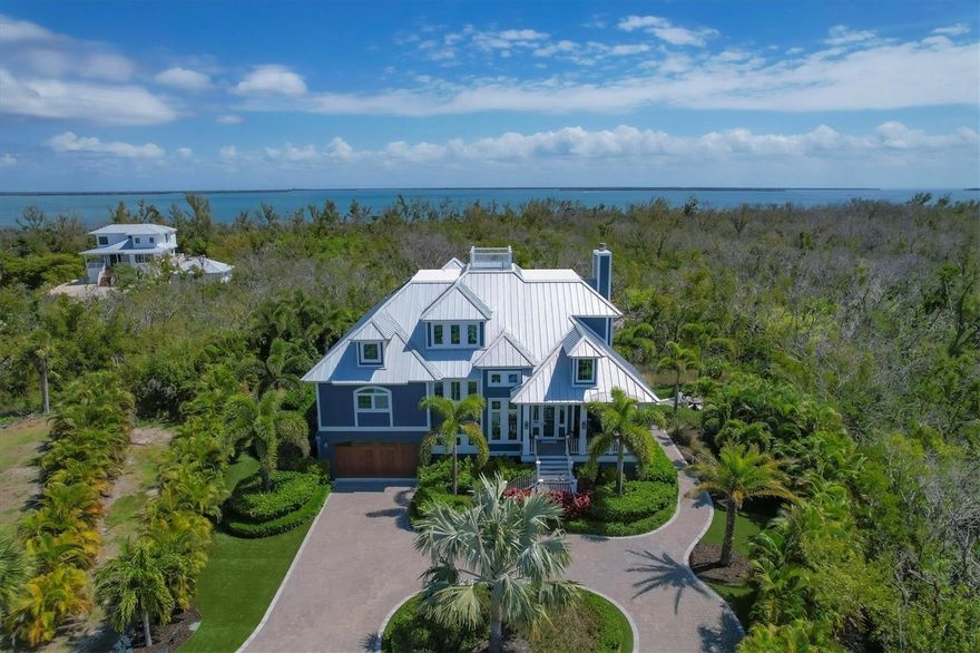 Custom 3 bedroom, 3 ½ bath Boca Grande pool home located in an extremely rare, private location, with over 2.1 acres at end of quiet cul de sac. The Sellers built this Safety Harbor home in 2018 with extraordinary detail with 3,288 SF of ac living and 5,949 SF overall, including multiple decks and patios!. The main level consists of hard wood floors throughout including the kitchen and master bedroom, the living room has a gas fireplace and cathedral ceilings, and the large, screened porch overlooks the quiet nature of old Florida. Beautiful Cambria Quartz Countertops, stainless steel Jenn-Air appliances and custom cabinetry appoint this large chef’s kitchen. The master bedroom is your own private oasis, with a large bathroom that has custom tile, a large, tiled shower and separate soaking tub. A grand staircase takes you to second living level with 2 large bedrooms with ensuite custom baths as well as a separate loft area that can be used for additional living, office or sleeping. All impact windows and doors, HardiPlank exterior with spray foam insulation provide the homeowner with maximum energy efficiency as well as all season protection. The outdoor living is second to none with a large pebble Tec and fenced heated pool with pavers, firepit and custom landscaping with no maintenance grass, outdoor shower and a garage plus additional ground level storage.