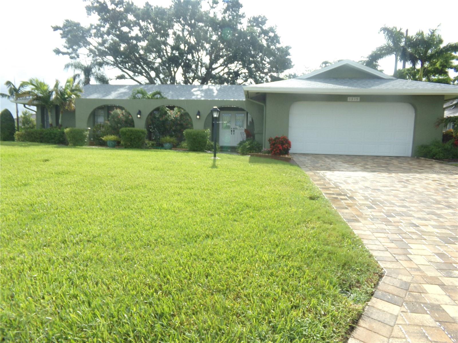 Welcome to your slice of Florida paradise, where convenience meets coastal charm! This home’s location is unbeatable, tucked away on a quiet side street in the heart of beautiful Village Green, one of Bradenton’s most beloved and established neighborhoods. Best of all, this home is just 5.5 miles from the white sands of Holmes Beach on Anna Maria Island! From your home to the ocean in just 10 minutes! RECENT UPDATES include a new roof in 2023, all new kitchen appliances in 2021 and replumbed water lines in 2020. The neighborhood also features a VOLUNTARY HOA and NO CDD fees!
This beautifully maintained 3-bedroom, 2-bathroom home offers a split bedroom floor plan that exudes comfort and style. Step inside and discover a spacious interior featuring arched doorways and an entryway, living room and office that all flow openly from one into the next, aglow with ample Florida sunlight from the large living room windows. The large master suite offers double closets and a private en-suite bathroom with a walk-in shower. Situated on the opposite side of the home, the second bathroom is conveniently tucked between the second and third bedrooms providing a practical layout for shared living or guest accommodations. The third bedroom in particular doubles as a hobbyist’s haven, complete with built-in cabinetry and countertops which make it easy to keep your crafts stored and organized!
The heart of the home is the updated kitchen and its seamless transition into the open dining room. The kitchen is designed with the passionate cook in mind, complete with granite countertops and a full suite of stainless-steel GE appliances, including built in microwave, flat top stove and wall oven. The dining room’s impressive size makes it a natural gathering point for all your entertaining needs. Enjoy year-round natural light in the generous sunroom, which boasts a passthrough from the kitchen and a stunning wall of windows overlooking the private backyard. Whether you're gathering with friends and family or unwinding alone, this is a space that invites relaxation.
The home includes a dedicated laundry room with a walk-in pantry and a 2-car garage, which features a workbench, storage closet and multiple wall mounted tool racks, perfect for any builder/fixer/tinkerer and all their hands-on projects! Outside, the fully fenced backyard is a true retreat, highlighted by a majestic shade tree and cozy brick patio. Don't miss your chance to own this beautifully updated home in a prime location, that combines the appeal of a quiet neighborhood with proximity to beaches and a plethora of options for all your shopping, dining, and recreation needs!