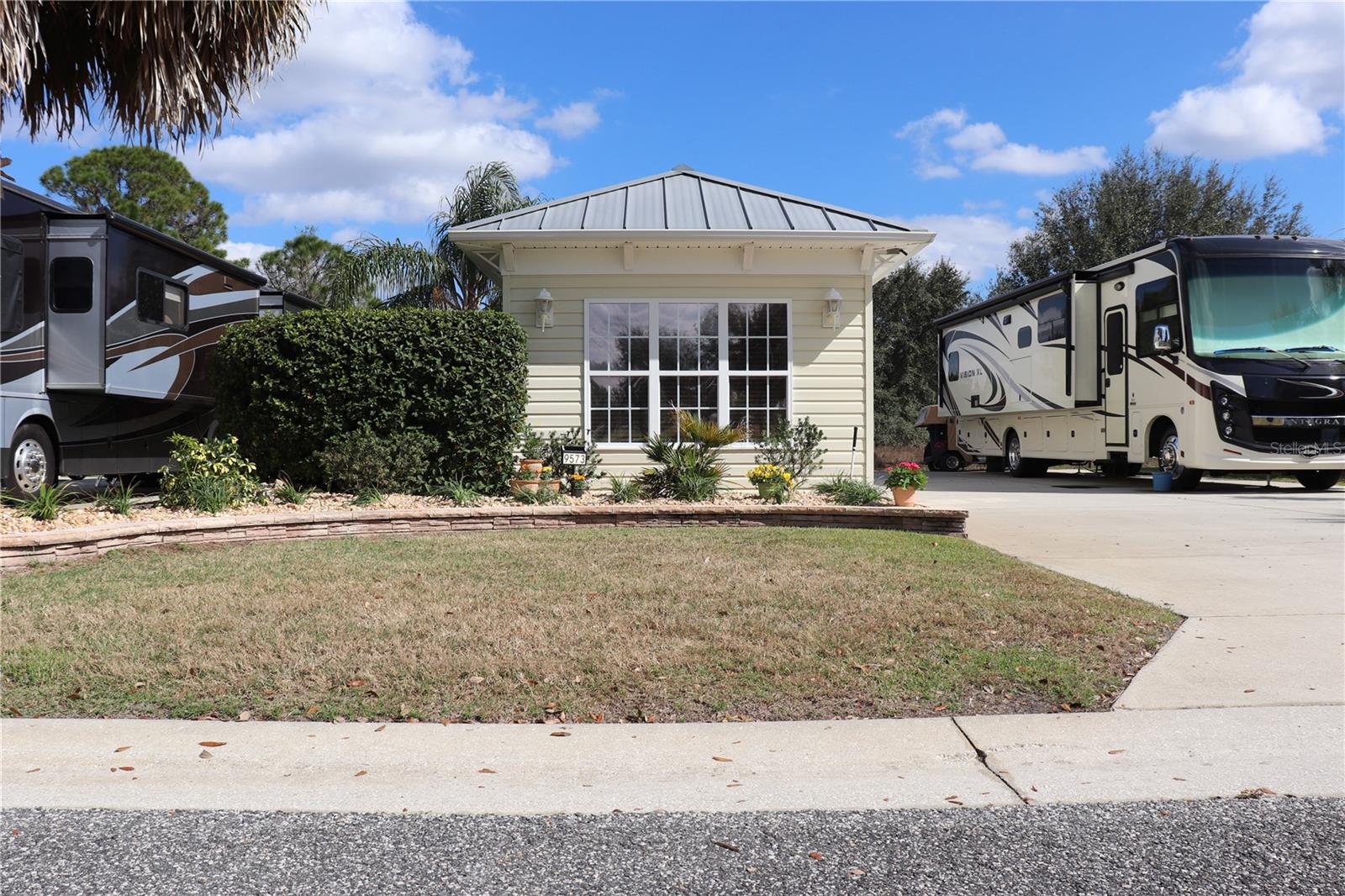 Don't miss this incredible opportunity to own Lot 253 in the highly sought-after Florida Grande
Motor Coach Resort! This 5,076 sq. ft. back-in property features a 26' x 76' concrete pad
with full motorhome hook-ups and is ideally located just steps from the pool and clubhouse,
giving you easy access to the resort’s top-tier amenities and vibrant social scene. Included with
the lot is a move-in ready, fully furnished 384 sq. ft. Grande Suite, designed for comfort and
convenience. Inside, you'll find a stunning trey ceiling, elegant tile flooring, upgraded
cabinets with solid surface countertops, and a full bathroom with a walk-in shower and
glass doors. The stacked full-size washer and dryer make everyday living effortless. Plus, the
back storage area is completely walled off with a separate door, creating a true garage and
extra storage space—a rare and valuable feature! Additional upgrades include a water softener
and ample storage throughout.
Florida Grande is a premier, gated Class A & Super C motorhome resort, centrally located
just an hour from Tampa, Orlando, and Ocala, and less than 30 minutes from The Villages.
Stay as busy as you’d like with a packed calendar of activities, events, and access to the brand
new 8-court pickleball complex, newly resurfaced pool, 10-person spa, and 20,000 sq. ft. clubhouse featuring newly refreshed main gathering room,
a fitness center, billiards room, craft room, and more.
This lot is priced to sell, and opportunities like this don’t last! Call today to schedule your
private tour before it’s gone!