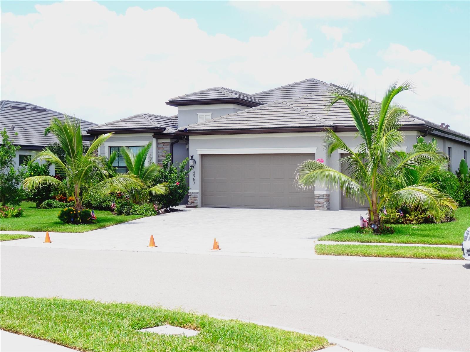 Live the Florida lifestyle! This stunning, Mediterranean Revival architectural style 4-BEDROOM POOL home is perfectly nestled within a QUIET, GATED COMMUNITY of Lorraine Lakes in Lakewood Ranch. This functional 4-BEDROOM FLOOR PLAN WITH 9+ FOOT CEILINGS, thoughtfully designed for modern living, features a versatile FLEX SPACE which provides endless possibilities, ideal as a FORMAL DINING ROOM or home LIBRARY/STUDIO. To complement your well-being, enjoy PURIFIED WATER throughout with a kitchen REVERSE OSMOSIS SYSTEM, WATER SOFTENER and WHOLE HOUSE FILTRATION. Step outside to your PRIVATE PARADISE and discover the custom-designed SALTWATER POOL, specifically shaped for both laps and lounging. Your future home boasts a PRIME WATERFRONT LOCATION with beautiful views, offering the perfect backdrop for relaxation. Imagine starting your day by watching the sunrise or unwinding with a margarita as the sun sets from your spacious patio. The property features EXTENSIVE LANDSCAPING with MATURE PLANTS AND PALM TREES creating a serene and private oasis. LAWN MAINTENANCE IS INCLUDED IN YOUR HOA! For the culinary enthusiast, the OUTDOOR KITCHEN, plumbed with propane gas, ensures exceptional cooking experiences al fresco while your indoor kitchen is set-up with NATURAL GAS for professional cooking and baking results. Built with robust CONCRETE BLOCK CONSTRUCTION and crowned with a durable TILE ROOF, this home promises lasting quality. Storage is plentiful with many spacious closets throughout, complemented by a large 3-CAR GARAGE. Convenience is key with HOT WATER ON DEMAND. Beyond your private retreat, the community enhances your lifestyle. A fantastic HOA offers residents access to a sparkling COMMUNITY POOL, TENNIS COURTS, a well-equipped GYM, and much more, fostering a lively and engaging environment The location is truly unparalleled: enjoy the tranquility of your neighborhood, with the AMAZING BEACHES OF ANNA MARIA ISLAND, renowned for their pristine shores, conveniently located nearby. Additionally, a mere 20-minute drive connects you to many amazing amenities, including diverse dining, premier shopping, entertainment, and essential services. Imagine yourself here!