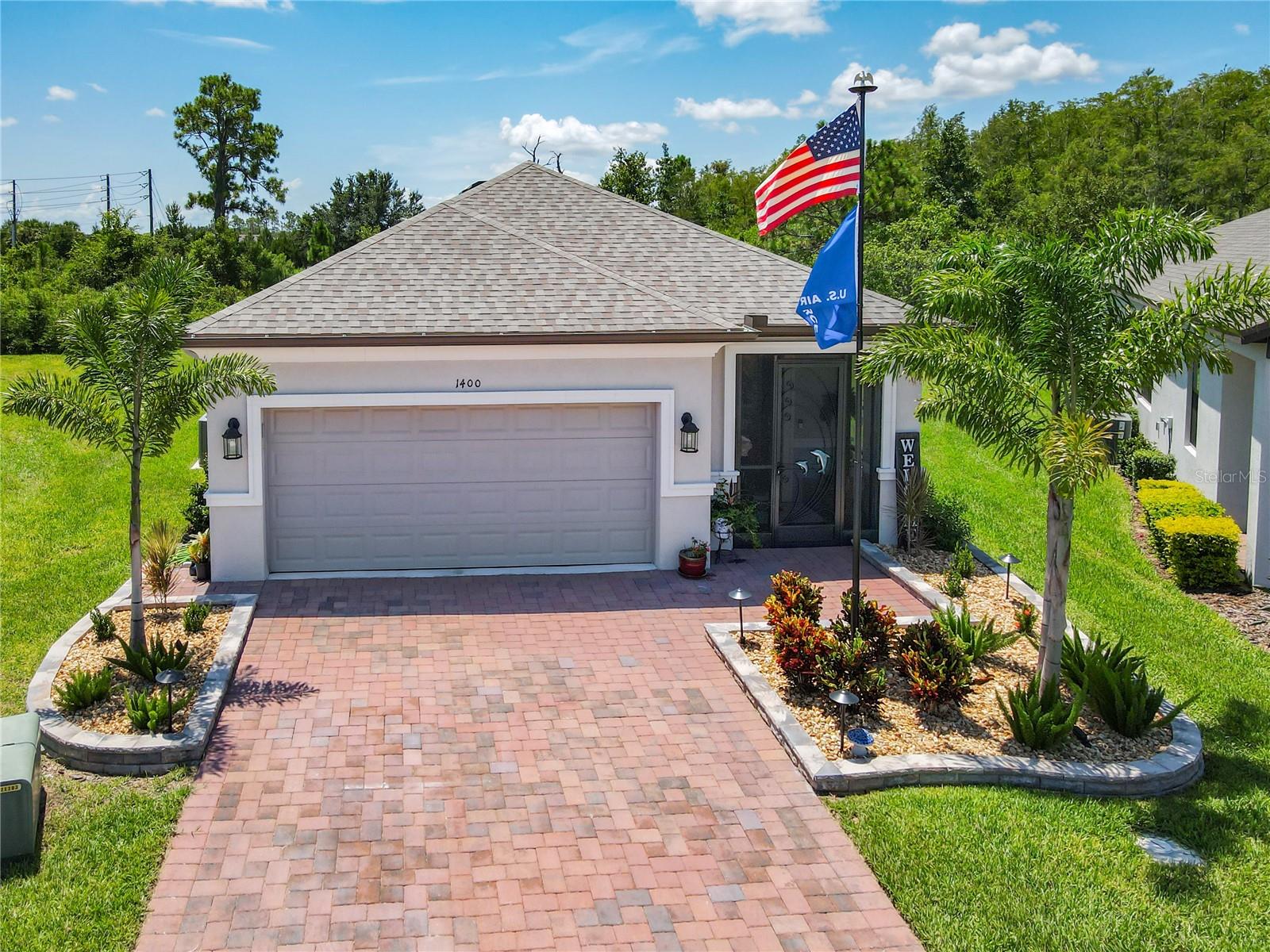 Welcome Home to 1400 LOMBARDI COURT, a like new MAGARI Model Home constructed in 2024 situated on an OVERSIZED Pie Shaped Lot with CONSERVATION View in a quiet Cul de Sac. Located in the Varese Neighborhood of Solivita this Popular Model Home has 3 Bedrooms, 2 Baths, Dining Room, Kitchen and a Large Gathering Room PLUS a 3 season room and an Extended, Covered and Screened Lanai. TONS OF UPGRADES including 8' Doors, LEVEL 5 TILE Plank Floors Throughout, CROWN MOLDING and a Lovely View. The Kitchen is equipped with RECESSED LIGHTING, QUARTZ COUNTERS, STAINLESS APPLIANCES, TILE BACKSPLASH, Espresso Cabinetry with SOFT CLOSE and Lower PULLOUTS, an UNDERMOUNT STAINLESS FARM SINK, plus a large WALK-IN PANTRY. Both BATHS have TILED SHOWERS and QUARTZ COUNTERS.. The LARGE Laundry Room features UTILITY SINK and LOTS of Storage. ADDITIONAL UPGRADES include TREY CEILING in the Dining Room and the Gathering Room, Energy Efficient DUAL PANE Tilt in Windows, a Culligan Whole Home WATER SOFTENER, a "Pur" WATER SYSTEM in the Kitchen, EPOXY Garage Floor and ENHANCED garden LANDSCAPING. One Guest Bedroom has a Murphy bed and desk while the other Guest Bedroom is a flex space and currently being used as a craft room. ENERGY EFFICIENT with Taylor Foam Insulation, this home is an exceptional value. The Lanai has been extended and expands your living and entertaining space. This home is beautifully positioned with expansive conservation views and plenty of space between you and your neighbors. Solivita is an Award Winning 55 PLUS Golf Cart Community in Central Florida, conveniently located with 30 minutes from the Amusement Areas, but worlds away for relaxation and enjoying the retirement lifestyle. Our community is guarded and gated 24/7 and golf cart friendly. Swim in any or all 14 temperature controlled pools, play pickleball, softball, horseshoes, bocce ball, or tennis. Work out in two State of the Art Fitness Centers complete with the latest equipment, trainers and classes. Play golf on 2- 18 Hole PGA Championship Courses, dine in our restaurants, fish in the ponds, garden in the community garden or take ”your best friend” to the Dog Park. Our Village Center is complete with entertainment, meeting spaces, a pro shop, hometown pharmacy/sundries store, a library, and a lively mix of fun. Shop at the Farmer's Market, enjoy a slice at the Bistro or a burger and a cocktail at the Grille. The HOA includes all landscaping and irrigation, fiber optics providing cable and internet, and security. Across the street are a hospital and medical offices as well as Poinciana Plaza Shopping Center featuring Sprouts Market, Outback Steakhouse, First Watch, TJMAXX, Ross, Ulta Beauty, Rack Room Shoes, 5Below and much more. If you are ready to start enjoying your retirement, Solivita is the perfect place to call home! If you are looking for a MOVE IN ready home, call today to make an appointment for your private viewing!