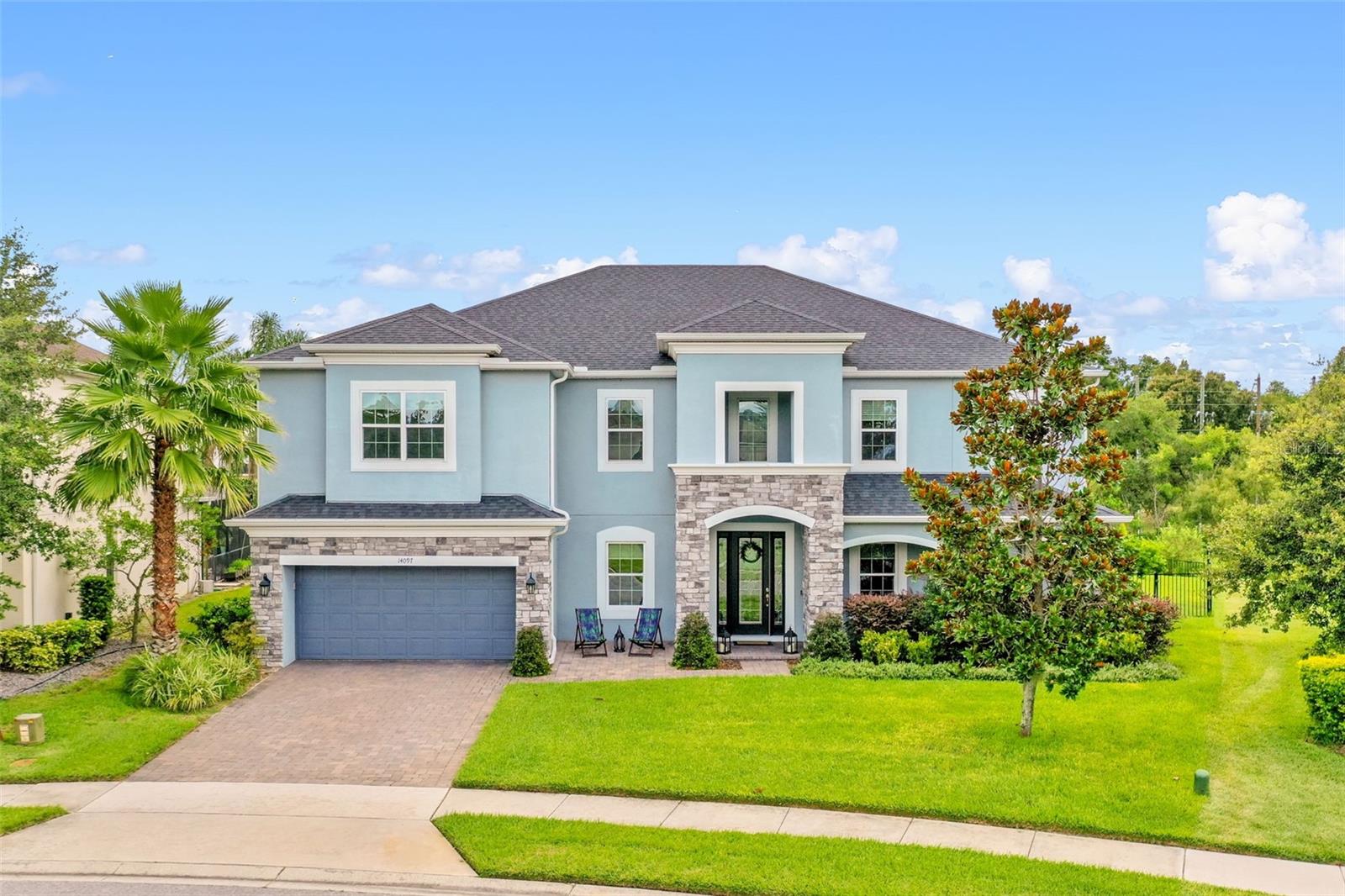 This stunning 4,800+ sq ft, single-family home seamlessly blends luxury living with family functionality, creating the perfect sanctuary for discerning homeowners. Designed with both relaxation and productivity in mind, this exceptional property caters to families seeking space and sophistication, as well as professionals requiring elegant work-from-home solutions. The spectacular kitchen serves as the centerpiece of this magnificent home, featuring a modern blend of form and function. Crisp white cabinetry with maximum storage and the expansive center island, finished in complementary gray tones, provides abundant workspace and casual dining.
Premium stainless steel appliances, including hob with natural gas, cater to culinary enthusiasts. The striking geometric backsplash in complementary tones adds visual interest and enhances the elegant quartz countertops. A farmhouse-style apron sink with upgraded faucet anchors the island, while industrial-inspired pendant lighting provides both task and ambient illumination. The open-concept design flows seamlessly into the adjoining living spaces, making it ideal for both intimate family meals and grand entertaining. The thoughtfully designed floor plan includes seven generously sized bedrooms and four full bathrooms, with a convenient downstairs primary suite and guest suite for main-floor living. Five additional bedrooms upstairs provide ample space for large families or multi-generational living arrangements. Premium amenities elevate everyday living with a dedicated movie room for cinematic experiences, a large den featuring a built-in bar for all types of entertaining, and a private gym for maintaining an active lifestyle. The breathtaking outdoor living space showcases a stunning resort-style pool complex that serves as the crown jewel of this luxury home. Enclosed within an expansive screened lanai, the area seamlessly blends indoor comfort with outdoor living, providing year-round enjoyment while maintaining protection from the elements.
The centerpiece is a magnificent rectangular pool with crystal-clear blue water, complemented by an elegant elevated spa featuring exquisite glass mosaic tile work. The elevated spa creates a beautiful focal point with its geometric design and seamless integration with the main pool. Premium travertine pavers throughout the expansive deck area provide both beauty and functionality, offering ample space for lounging and entertaining. The practical home office exemplifies modern luxury with its thoughtful design and premium finishes. Framed by an elegant arched entry, this dedicated workspace features floor-to-ceiling built-in cabinetry in crisp white, providing abundant storage while maintaining a clean, organized aesthetic. The centerpiece is a sleek white desk island that accommodates dual workstations, perfect for collaborative work or separate professional endeavors. A three-car garage plus additional driveway parking for two vehicles ensures convenience for busy families and frequent guests. Every detail has been carefully considered to provide the ultimate in luxury living while maintaining the warmth and functionality essential for family life. This extraordinary property offers the rare combination of luxury amenities and family practicality. From the professional office space that supports career success to the entertainment areas that create lasting memories, every square foot has been designed with purpose.