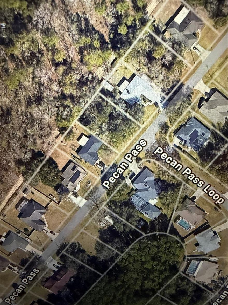 Build Your Dream Home on this nearly 1/4 acre lot with NO REAR NEIGHBORS in Silver Springs, Ocala! Experience the perfect blend of tranquility and convenience on this prime .23-acre lot in the highly desirable SILVER SPRINGS COMMUNITY of Ocala, Florida. Zoned R-1 and ready for your custom build, this spacious lot offers the ideal canvas for your dream home. Enjoy the freedom of NO HOA restrictions, providing privacy and flexibility while being minutes from Downtown Ocala, Gainesville, and The Villages. The property’s unbeatable location near MAJOR HIGHWAYS ensures easy commuting, while nearby shopping, dining, parks, and outdoor recreation add to its appeal. With Ocala’s RAPID GROWTH and the natural beauty of Silver Springs, this is your chance to invest in a thriving community. Don’t miss out—clear the lot and start building the lifestyle you’ve always envisioned today! Property is located in between 91 and 95 Pecan Pass.