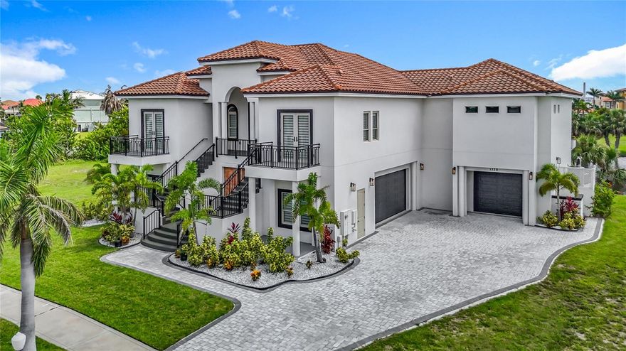 Preferred lender offering up to 1.25% credit toward buyer’s closing costs (subject to lender approval and buyer qualification). Step into elegance and coastal sophistication with this custom-built Mediterranean masterpiece, located in the prestigious 24-hour gated waterfront community of Andalucia, nestled on a private peninsula in Tampa Bay.

This block-constructed residence offers nearly 5,000 sq ft of heated living space and over 8,200 total sq ft, thoughtfully designed for style, comfort, and function. With 4 spacious bedrooms, 3 full bathrooms, and 2 half baths, every corner of this home delivers luxury living at its finest.

From the moment you arrive, you'll be greeted by a grand entryway with majestic dual staircases and a custom 8x8 ft fountain, setting the tone for what’s inside. Soaring 15-foot cathedral ceilings and wood-look porcelain tile floors create a breathtaking ambiance throughout the open-concept main level.

The gourmet kitchen is a chef’s dream, featuring quartz countertops with waterfall edges, real wood cabinetry, high-end stainless steel appliances, and a gas cooktop. The expansive living area seamlessly flows onto a covered balcony with stunning water views, the perfect setting for entertaining or relaxing.

But the true sanctuary of this home is the luxurious primary suite. Exceptionally spacious and filled with natural light, the room opens up to the main balcony through custom 90-degree pocket sliding doors, offering front-row seats to the sunset. Enjoy the comfort of motorized blackout shades, and escape to your own retreat with a fully customized walk-in closet that’s as stylish as it is functional. The en-suite bathroom feels like a spa, featuring a freestanding soaking tub, 15x4 ft walk-in shower with a 40-inch rain head, dual vanities, and backlit smart mirrors for the perfect glow.

On the lower level, discover multiple bonus rooms ideal for a game room, gym, or media lounge plus a flexible office space with its own private entrance, perfect for working from home or transforming into an epic man cave.

Car lovers will be thrilled with the oversized 3-car garage with finished flooring, easily fitting up to 5 vehicles depending on size.

Love the outdoors? There’s ample room to build your dream pool, and from the second-level terraces, you’ll enjoy sunrise views from one side and sunsets from the other... a true Florida dream.

As a resident of Andalucia, you’ll enjoy access to resort-style amenities including a private marina (slips for rent or purchase), clubhouse, community pool, tennis courts, playground, and a scenic fishing pier overlooking Tampa Bay.
