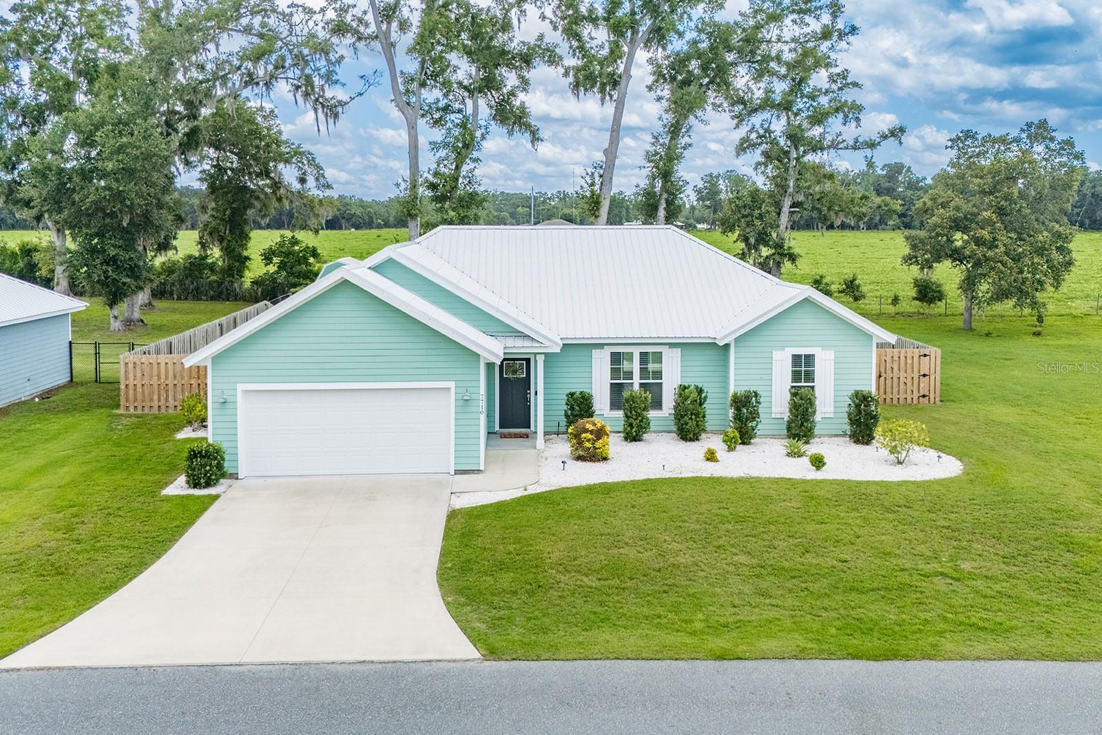 Welcome to this charming 3 bedroom, 2 bath home located in the highly desirable Riverwalk subdivision in Fanning Springs, FL. Nestled on a fully fenced lot, this well-maintained property offers privacy and space to enjoy the peaceful Florida lifestyle. The home features a spacious and open floor plan, perfect for both relaxing and entertaining. The kitchen is equipped with ample cabinet space, modern appliances, and a breakfast bar that flows into the dining and living areas. The master suite includes a walk-in closet and a private bath with dual vanities. Step outside and enjoy the beautifully landscaped backyard, complete with a cozy fire pit area—ideal for evening gatherings under the stars. A convenient shed provides additional storage for tools and outdoor gear. Riverwalk is a gated community with a welcoming small-town feel and access to amenities like walking trails, a clubhouse, and more. Located just minutes from the scenic Suwannee River, Fanning Springs State Park, and the Nature Coast State Trail, this home is perfect for those who love the outdoors. Whether you enjoy boating, kayaking, hiking, or biking, there’s always something to explore nearby. Shopping, dining, and medical facilities are also close by, offering both comfort and convenience. This move-in ready home offers the perfect blend of comfort, community, and natural beauty—don’t miss your chance to make it yours!