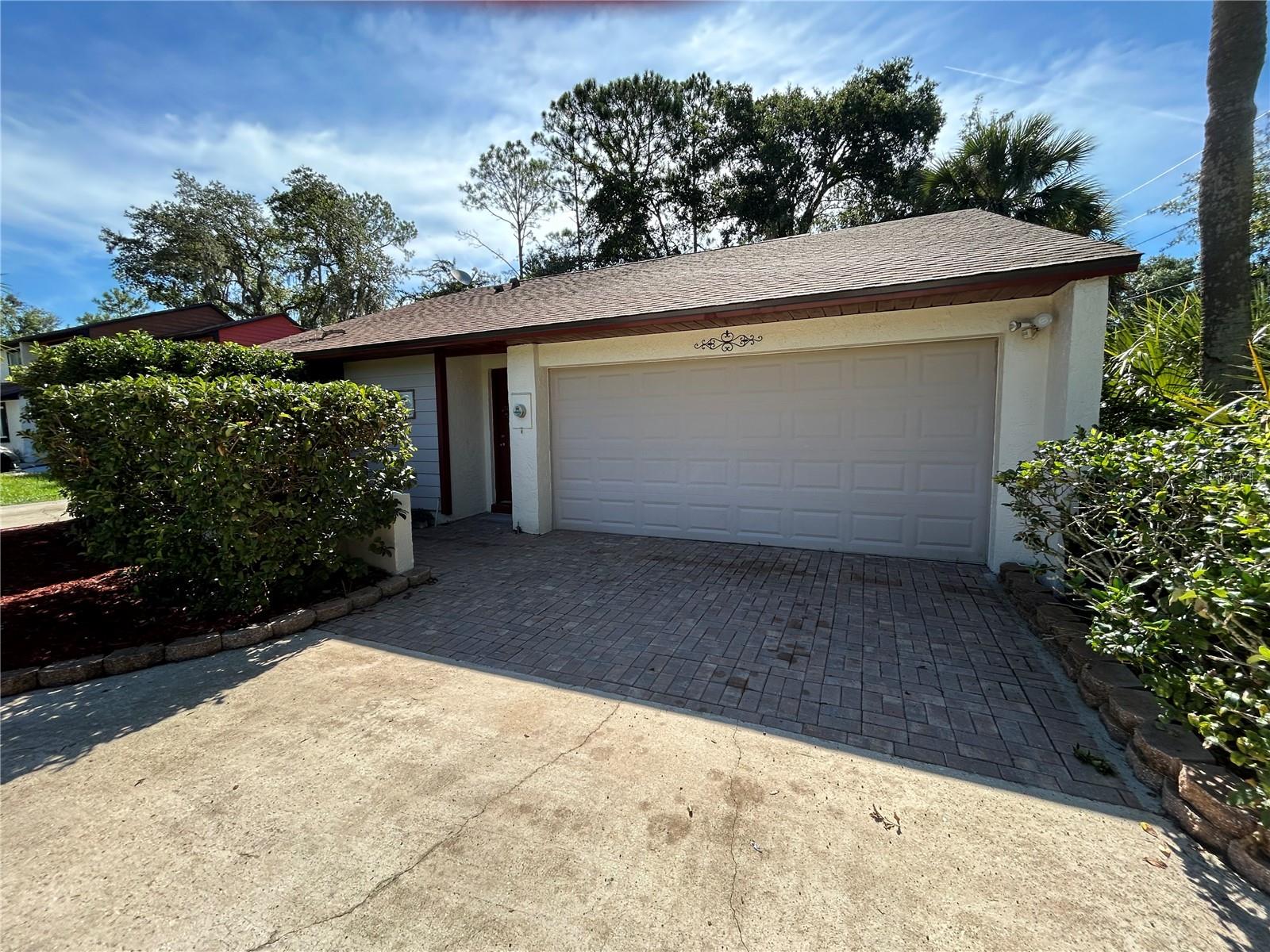 This spacious 2-bedroom, 2-bathroom townhome with a 2-car garage offers the perfect blend of comfort, style, and convenience. Located in the desirable Hidden Lake Villas community, you'll enjoy low HOA fees and an array of fantastic amenities.
Step inside to discover a beautifully updated kitchen featuring luxury granite countertops, a stylish tile backsplash, and modern appliances—including a new refrigerator, oven/hood, and dishwasher. The open-concept dining area flows effortlessly into a screened-in lanai, ideal for relaxing evenings or entertaining guests. The private garden space adds a tranquil touch of nature.
The home boasts new waterproof laminate flooring and a marble vanity in the primary suite. A long driveway offers ample parking and picturesque nature views from the front yard. The enclosed garage, currently used as a flexible space for an office or extra bedroom, can easily be converted back to a full 2-car garage to suit your needs.
Recent upgrades include a newer roof, water heater, and HVAC system—offering peace of mind for years to come.
