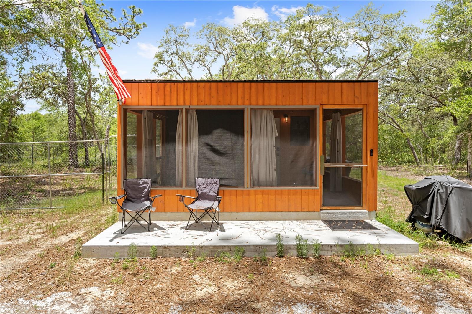 Currently operating as a successful Airbnb, with current bookings throughout the year!! Offering immediate cash flow for investors or a seamless transition for anyone looking to step into short-term rental ownership. You can now escape to your own private sanctuary with this stunning container home, perfectly nestled in the serene woods of Homosassa. Blending modern design with the natural beauty of Florida's landscape, this unique property offers the ultimate combination of comfort, style, and tranquility. Step inside to discover a thoughtfully designed open-concept living space filled with natural light, sleek finishes, and efficient use of space. The modern kitchen features stainless steel appliances, custom cabinetry, and solid surface countertops, making it perfect for both daily living and entertaining. Cozy bedrooms, a spa-like bathroom, and clever storage solutions make this home as functional as it is beautiful. Outside, enjoy your morning coffee or evening wine on the spacious deck, surrounded by towering trees and the peaceful sounds of nature. Whether you're watching the local wildlife or simply soaking in the quiet, this property offers a true escape from the hustle and bustle. Located just minutes from the Homosassa River, nearby springs, state parks, and the Gulf of Mexico, outdoor enthusiasts will love the endless opportunities for boating, fishing, kayaking, and hiking. With shopping, dining, and local attractions close by, you can enjoy both seclusion and convenience. Whether you're looking for a full-time residence, a weekend getaway, or an income-producing vacation rental, this one-of-a-kind container home is a rare find in today's market. Don’t miss your chance to own this peaceful modern oasis — schedule your private showing today! *Financing is accepted, however please speak with your lender to ensure they will approve a container home!