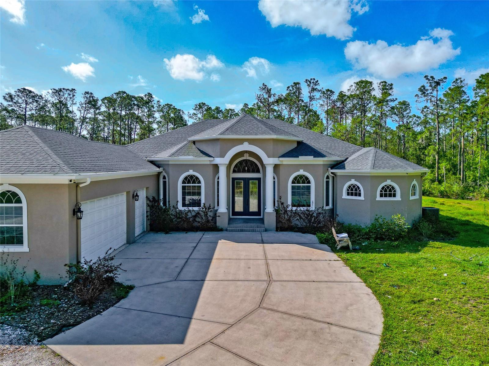 Opportunities like this are few and far between. Located in the sought-after community of Panther Ridge, this beautifully updated 4-bedroom, 3-bath pool home sits on 8 private acres and offers the space, peace, and flexibility that today’s buyers are looking for. Tucked away on a quiet, low-traffic street, the property welcomes you with a long shell driveway lined with mature trees, a serene pond, and plenty of open space— immediately setting a relaxed tone. Whether you're seeking room for horses, planning to build a detached garage or workshop, or simply want extra privacy and freedom to spread out, this land offers the potential to make your vision a reality. Inside, the home features a bright, open
layout with tall ceilings and spacious living areas that flow seamlessly. The great room is anchored by large pocketing sliders that fully open to the lanai and pool area—bringing the outdoors in and creating a perfect setting for entertaining or enjoying peaceful Florida evenings. The kitchen has been recently updated and includes Quartz countertops, solid wood cabinetry, and a unique tile backsplash that gives it a custom touch. All four bedrooms are generously sized, with a well-designed split floorplan that offers both privacy and functionality. The primary suite is a true retreat, featuring two walk-in closets and a spacious bath with dual vanities, a garden tub, and a luxurious walk-through shower. The guest bedrooms and bathrooms are equally well-appointed, offering plenty of space for family or visitors. Other highlights include a large
laundry/mudroom, ideal as a daily drop zone, and an oversized 3-car garage with room for storage, projects, or toys. The home is move-in ready, but also provides a solid foundation for future customization—especially for those with equestrian needs, collector vehicles, or simply a desire for more space. Panther Ridge is one of the area's most desirable acreage communities, known for its natural beauty, peaceful setting, and large lots that allow for flexibility. Yet you're just minutes from Lakewood Ranch’s shopping, dining, and top-rated schools, and a short drive to downtown Bradenton, Sarasota, and area beaches. Be sure to view the 3D virtual tour, and don’t miss your chance to walk this one-of-a-kind property in person. With land, location, and lifestyle all in one, this is a home that truly stands out.