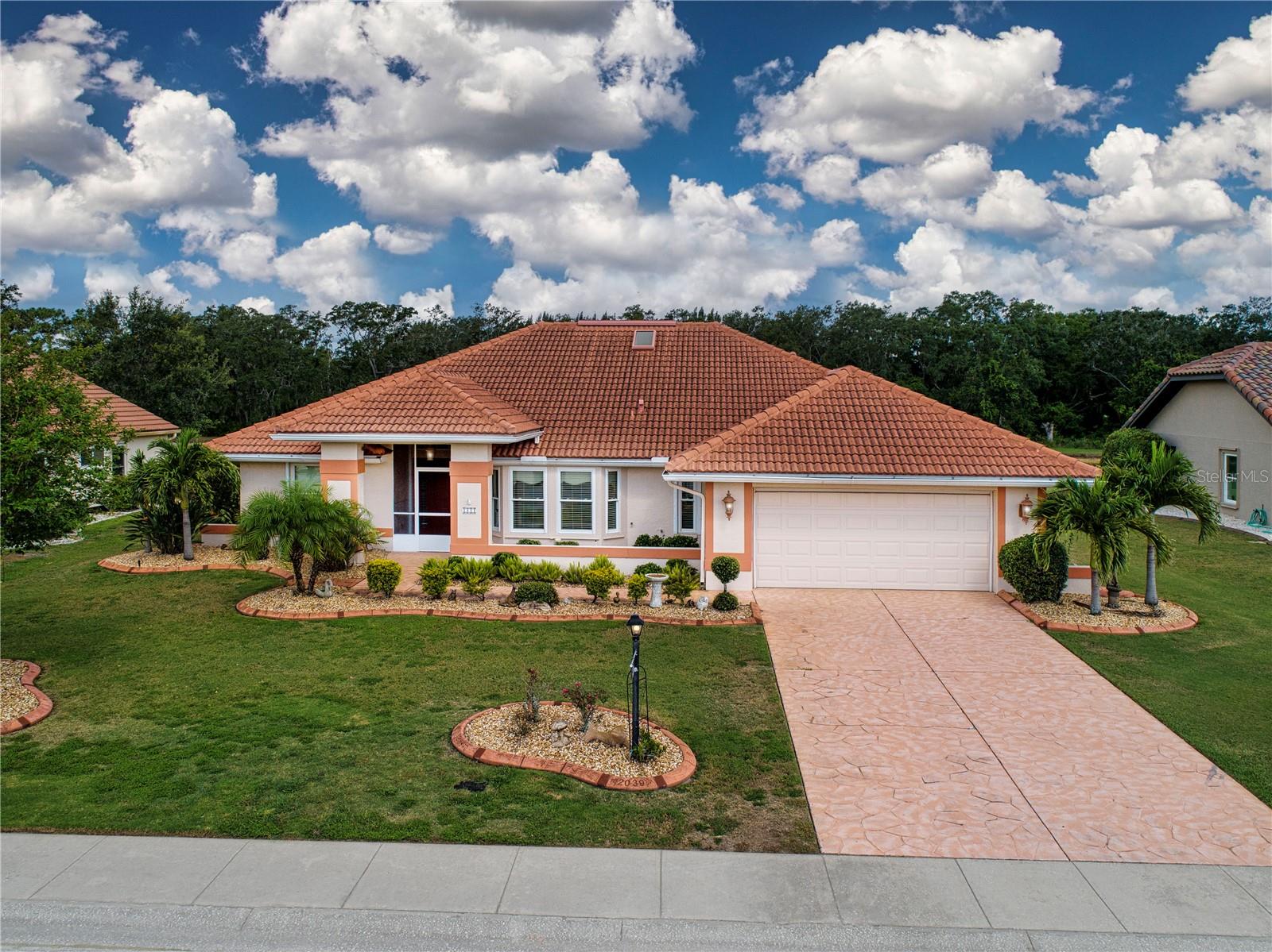 Imagine yourself in a more beautiful and better-maintained property. Water views and conservation from the living rooms, kitchen, master and guest rooms. From the screened lanai, watching the wildlife and Florida sunsets is priceless. Spacious home built for entertaining with vaulted ceilings, skylights, formal and informal living areas, and many upgrades. Split floor plan with 3 bedrooms and 2 bathrooms. The large master suite features 2 walk-in closets, a separate shower and spa/jetted tub, a linen closet, and 2 sinks. Enjoy peace of mind with electric roll-down hurricane shutters. Irrigate with lake water and save $$. Huge garage with built-in storage, laundry area, and entry with a screened in porch and tile. Upgrades from 2007 to present include new air conditioning, cherry cabinets with raised panel doors and pull-out drawers, countertops, hurricane garage door.