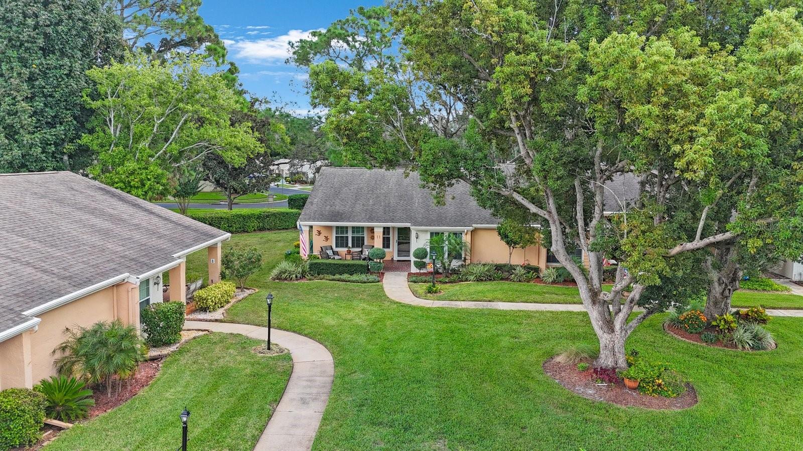What a Stunner, this end unit single story villa is in move in condition, lots of updates, gorgeous laminate wood flooring, incredible setting, low hoa fees, covered parking with storage, beautiful front porch overlooking the pond. large bedrooms, beautiful sunroom oversized kitchen with eating area, Primary bedroom has its own ensuite complete with double sinks, large walk in closet. Second bedroom also has it's own walk in closet. this complex features a gorgeous pool overlooking a beautiful pond with a fountain in the middle, tennis courts, large clubhouse, beautiful grounds. so convenient to shopping, restaurants, and all that new port richey has to offer.