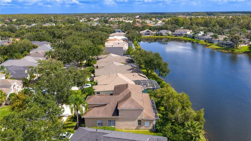 Executive home in Quail’s Landing of Arbor Greene, perfectly positioned on a waterfront lot and offering one of the best values in the community. At over 3,300 sq. ft., this is the best-priced large home in Arbor Greene. A rare find with dual master suites—one upstairs and one downstairs—this layout is ideal for multi-generational living or flexible use. The home features 4 bedrooms, 4 bathrooms, A downstairs flex room/office, an upstairs office, and a 3-car garage.  Spacious living areas filled with natural light and water views.

The dramatic two-story foyer opens to a formal living room with plantation shutters and custom millwork, leading into the open-concept main living space with 12-foot sliding doors to the screened lanai. Outside, enjoy an outdoor kitchen, spa, and pavered patio overlooking the water. The kitchen is finished with solid marble countertops, a center island, double ovens, 5-burner gas range, and stainless-steel appliances. Off the kitchen, you will find a large flex room that can be used as a downstairs office, play room, or private reading room. The first-floor primary suite has floor-to-ceiling windows with water views, a soaking tub, walk-in shower, dual vanities, and large closet. Upstairs includes a second master suite with vaulted ceiling and a spacious ensuite, plus two additional bedrooms and a home office with built-in desk and cabinetry. Roof replaced in 2016.

Arbor Greene offers 24/7 manned gates, clubhouse with event space, fitness center, Olympic-sized and resort-style pools, tennis courts, pickleball courts, playgrounds, and miles of walking paths and nature trails. Conveniently located minutes from I-75 with quick access to shopping, restaurants, hospitals, USF, and downtown Tampa. This home offers both space and value in one of New Tampa’s most established communities.