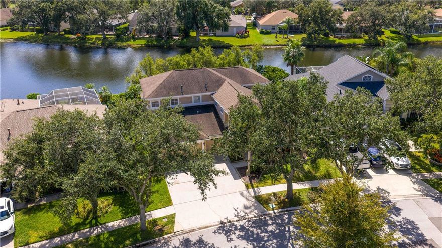 Executive home in Quail’s Landing of Arbor Greene, perfectly positioned on a waterfront lot and offering one of the best values in the community. At over 3,300 sq. ft., this is the best-priced large home in Arbor Greene. A rare find with dual master suites—one upstairs and one downstairs—this layout is ideal for multi-generational living or flexible use. The home features 4 bedrooms, 4 bathrooms, A downstairs flex room/office, an upstairs office, and a 3-car garage.  Spacious living areas filled with natural light and water views.

The dramatic two-story foyer opens to a formal living room with plantation shutters and custom millwork, leading into the open-concept main living space with 12-foot sliding doors to the screened lanai. Outside, enjoy an outdoor kitchen, spa, and pavered patio overlooking the water. The kitchen is finished with solid marble countertops, a center island, double ovens, 5-burner gas range, and stainless-steel appliances. Off the kitchen, you will find a large flex room that can be used as a downstairs office, play room, or private reading room. The first-floor primary suite has floor-to-ceiling windows with water views, a soaking tub, walk-in shower, dual vanities, and large closet. Upstairs includes a second master suite with vaulted ceiling and a spacious ensuite, plus two additional bedrooms and a home office with built-in desk and cabinetry. Roof replaced in 2016.

Arbor Greene offers 24/7 manned gates, clubhouse with event space, fitness center, Olympic-sized and resort-style pools, tennis courts, pickleball courts, playgrounds, and miles of walking paths and nature trails. Conveniently located minutes from I-75 with quick access to shopping, restaurants, hospitals, USF, and downtown Tampa. This home offers both space and value in one of New Tampa’s most established communities.