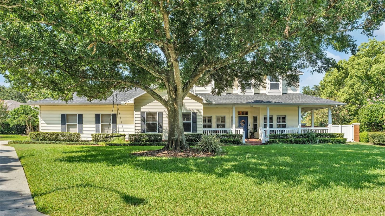 Welcome to this stunning 3,609 sq. ft. two-story home nestled in desirable South Lakeland, where timeless traditional charm meets modern comfort. Situated on a generous .57-acre lot, this property is graced by a stately wrap-around porch, a majestic oak tree, and lush, mature landscaping that creates an inviting and picturesque setting. Large driveway leads to a two care garage with attic access and storage racks. Inside, you’ll find four spacious bedrooms and three and a half baths, with generously sized rooms throughout. The expansive living and dining rooms are ideal for gatherings, each offering French doors that open to a bright Florida Room, perfect for enjoying the view of the backyard oasis. The kitchen is a chef’s dream, featuring granite countertops, abundant cabinetry, a reverse osmosis system, and high-end GE Café Collection appliances, including a double oven. The large eat-in area easily accommodates a big family table for meals or game nights. Just off the kitchen is a delightful 6x14 bonus space with a window — ready to be your craft room, playroom, or transformed into an enviable walk-in pantry. The first-floor laundry room includes extra storage with ample cabinetry and a convenient closet. Upstairs, the primary suite is a true retreat with a 16x12 bedroom, a barn door leading into the beautifully updated ensuite bath with double vanities, a spa tub, a separate shower, and relaxing shiplap details. The custom walk-in closet is designed to impress. Two bedrooms share a spacious Jack and Jill bath with dual vanities and a tub/shower combo, while the fourth bedroom enjoys its own private bath with a shower. An additional bonus room with a massive walk-in closet offers flexibility as a cozy TV room, playroom, or easily converted in-law suite. Step outside to your private resort-style backyard featuring a paver patio and pool deck surrounding an impressive 35x11 pool, perfect for swimming laps or lounging on sunny Florida days. A charming pool shed or playhouse with electricity adds to the appeal, and the entire backyard is enclosed by a beautiful brick wall — a rare find that offers privacy and peace of mind. This exceptional property truly feels like a personal retreat while providing all the space and features a modern family desires.