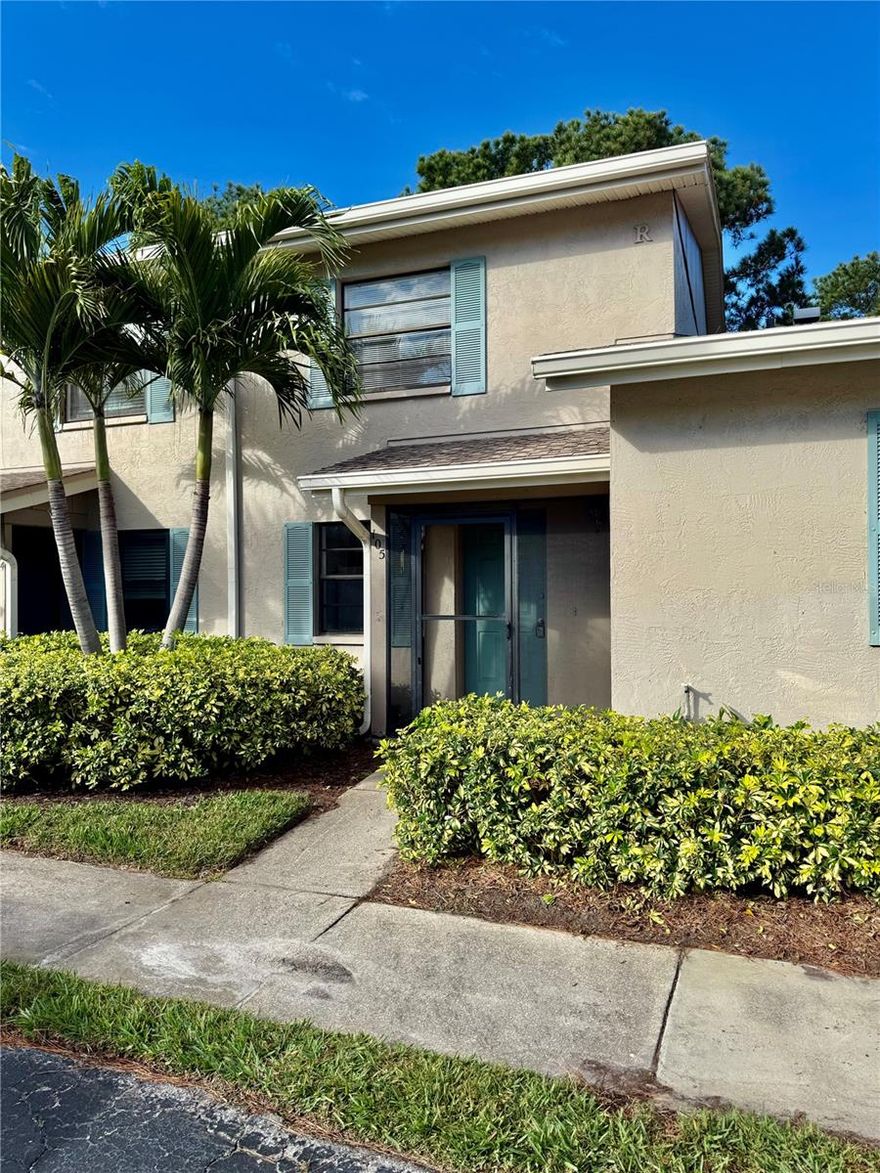 Come take a look at this wonderfully located townhome just 5 miles from Pinellas County's Beaches!  This 2 bedroom, 1.5 bath unit has nice views of the pool and landscaping from either the main level lanai, or from the Primary Bedroom porch on the upper level.  The floorplan is spacious with tile floors in the living areas, and brand new carpeted stairs and upper floor bedrooms.  The kitchen is sized just right with ample room for a table, and it also features an open bar overlooking the main living area.  Parking is easy with one assigned spot a few steps from the front door, and many guest spots available close by.  Take a dip in the pool, or test your skills on the community tennis courts!  This property is available today for your enjoyment!