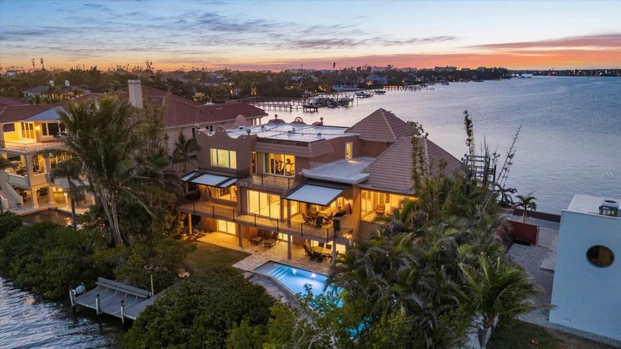 Welcome to 1364 Point Crisp, a breathtaking waterfront home on one of the most private and interesting streets on Siesta Key. With only seven homes on this secluded section of road, you’ll enjoy peace, quiet, and incredible views of Little Sarasota Bay and the Intracoastal Waterway. Watch sailboats glide by or fishermen return from a great day out in the Gulf. This home is a boater’s dream, featuring a 16,000# boat lift and a 10,000# personal watercraft lift not to mention a separate day dock and kayak Launch in the back yard. The heated saltwater pool was custom built and features a spacious deck, and plenty of room to entertain family and friends. Relax on one of the two large second-floor balconies with an outdoor grill area and roll-down screens—perfect for enjoying a glass of wine while watching the sunset. Other features include: a 100KW Kohler commercial backup generator powered by natural gas, Impact-rated doors and windows, well water for irrigation and city water access at multiple points, including the dock. Six climate-controlled garage spaces plus tons of extra storage on the first level, with easy access to the backyard and pool. Inside, with an elevator serving all levels of the home, you’ll find 4 spacious bedrooms, 5 full bathrooms, and a modern kitchen with a Sub-Zero refrigerator, Thermador induction cooktop, and GE Monogram appliances. The wet bar includes a beverage fridge and extra storage—perfect for entertaining. This home has been meticulously maintained and offers countless hidden conveniences that make life easier. Don’t miss your chance to own this incredible waterfront retreat!