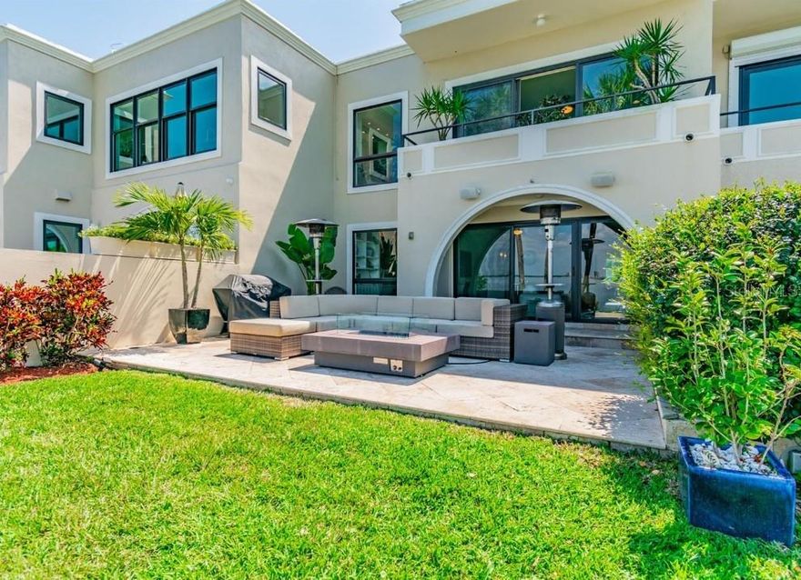 A elegant and contemporary, direct waterfront townhome with sweeping views of the Hillsborough Bay and Tampa’s city skyline. Located in Hawthorne Point, a gated private community with only ten owners and situated just off Bayshore Boulevard. This townhome features exceptional quality and exquisite design details. This open concept floor plan is ideal for entertaining. The kitchen has been remodeled with solid wood, custom-built cabinetry, granite countertops and stainless steel appliances. Other features include crown molding, travertine tile floors downstairs, wood floors upstairs, built-in bookshelves/cabinetry and a wet bar, complete with a wine cooler and an elevator. New hardwood flooring in the second floor and AC is less than 5 years old. The owner’s retreat features a very spacious walk-in closet with a custom closet system, electric window shades and a balcony overlooking the water. Carry the entertaining outside onto the spacious travertine tiled patio, equipped with surround sound and custom lighting. Enjoy the dolphin, stingray or manatee sightings right off your seawall! This is truly a special property and a rare opportunity to buy into this exclusive community.