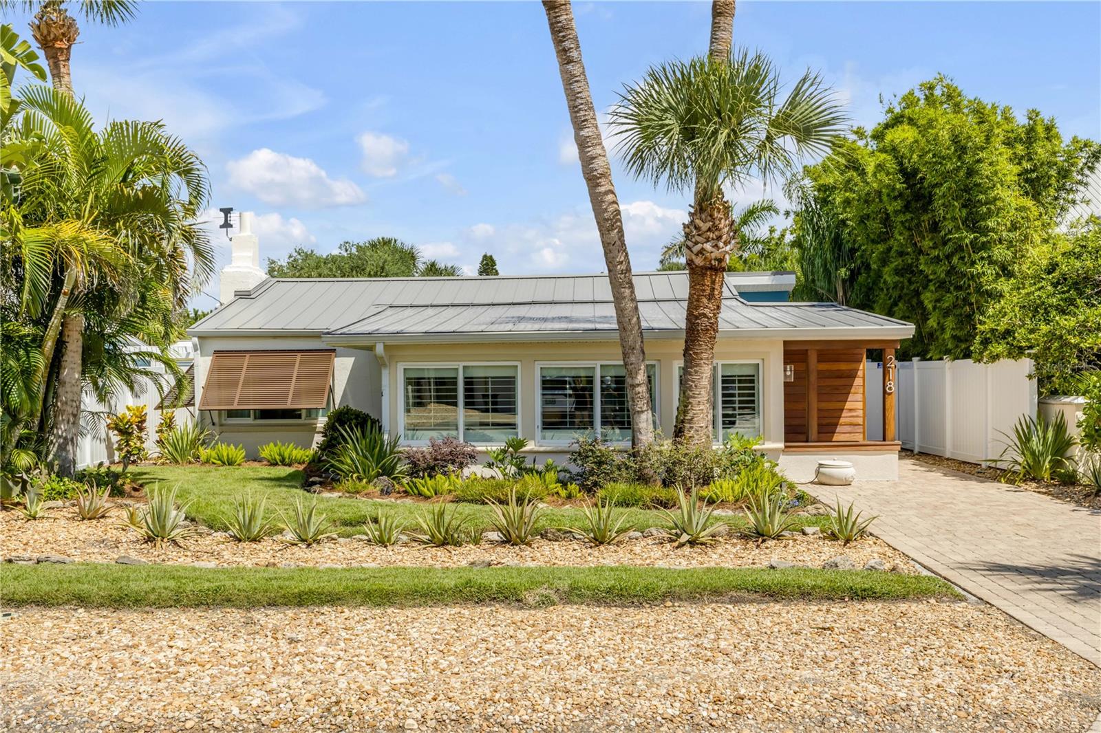 WOW factor renovations!!! North Beach location, just a short stroll to the ocean and within walking distance to Flagler Avenue Historic District with its restaurants, shops, and entertainment. This block home with a metal roof is ideally positioned between the Atlantic Ocean and the Intracoastal Waterway, offering the best of coastal living. Perfect as a personal beach retreat, this home presents an excellent opportunity in one of New Smyrna Beach’s most desirable neighborhoods.
The chef’s kitchen opens to a soothing backyard with an attractive patio shaded by olive, lemon, and lime trees: an ideal entertainment space.
Improvements include:
2014: Tile flooring throughout, hurricane windows, and plantation shutters in the sunroom and kitchen.
2015: Added master bath with glass door and walk-in shower, front and backyard irrigation system with a 2024 controller.
Landscaping: Extensive rock beds, 10 palm trees, exterior Bahama shutters on primary windows, and a 12×10 storage shed.
2023–2024 Remodel: Kitchen addition with a 9-foot island, Fisher & Paykel appliances, convection cooktop, Kohler enamel deep sink and faucet, Cabico cabinets, rollout shelves, and 6-foot French doors to the exterior. Updates also include a half bath, metal standing-seam roof, heat pump, air handler, electrical panel, IPE wood exterior at the front entry, fresh interior and exterior paint, ceiling fans in the living room, bedrooms, kitchen, and master bath, plus a Halco 6-foot white vinyl fence with two gates. Buy it today and move in tomorrow! Move-in luxury homes like this one are rare!