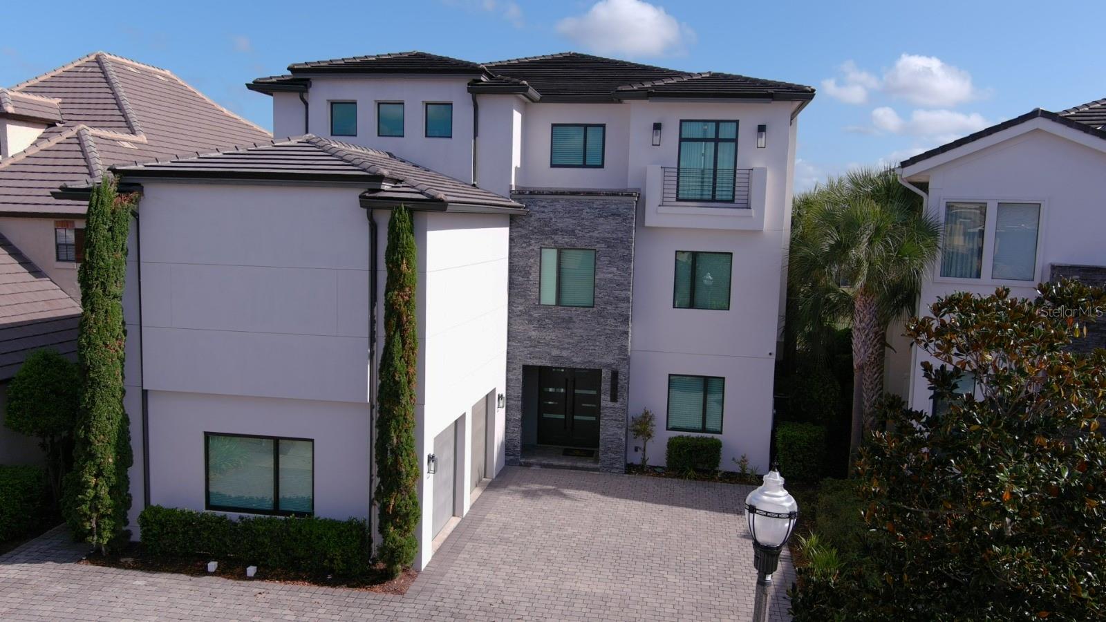 Construction of luxury, top-notch homes. A turnkey, three-story, income-producing investment property right out of the box, with 10 bedrooms and 11 full and 3 half baths, offering everything needed to generate an immediate income stream. This luxurious property is custom-designed and built specifically to be a vacation home, with an abundance of rooms professionally designed and decorated to suit different tastes and expectations, providing maximum impact for those seeking high-priced accommodations. The owner has made many updates throughout the home, including impact-proof windows and doors. No expense has been spared to ensure this home is immaculate and best in class. Play a game of pool in the large billiards room, watch a movie with your seasoned family found in a high-end movie theater or simply play with your family in the game room suitable for all ages. Furniture is included. The view from the third floor of the Jack Nicklaus 14th Green is exceptional and offers a location that matches the individual 5-star qualities of this property. The world-famous Reunion Resort, unique in the world offers 3 championship golf courses, private membership that is currently active by its owner, an exceptional community water park, a lazy river, slides, outdoor games and water play area, tennis and golf centers, a spa, several fine dining restaurants and is only 7 miles south of Walt Disney World. They give free transportation to the Disney Transportation Center and the ticketing center leaves from the Grande daily. Pictures do not do this property justice, you must see this home for yourself so be sure to stop by and see one of Reunion's premier luxury vacation investment homes. One of the largest homesites in the Legend's Corner neighborhood at Reunion Resort. The community offers three separate 24-hour guarded entrances and one owner/resident-only entrance.