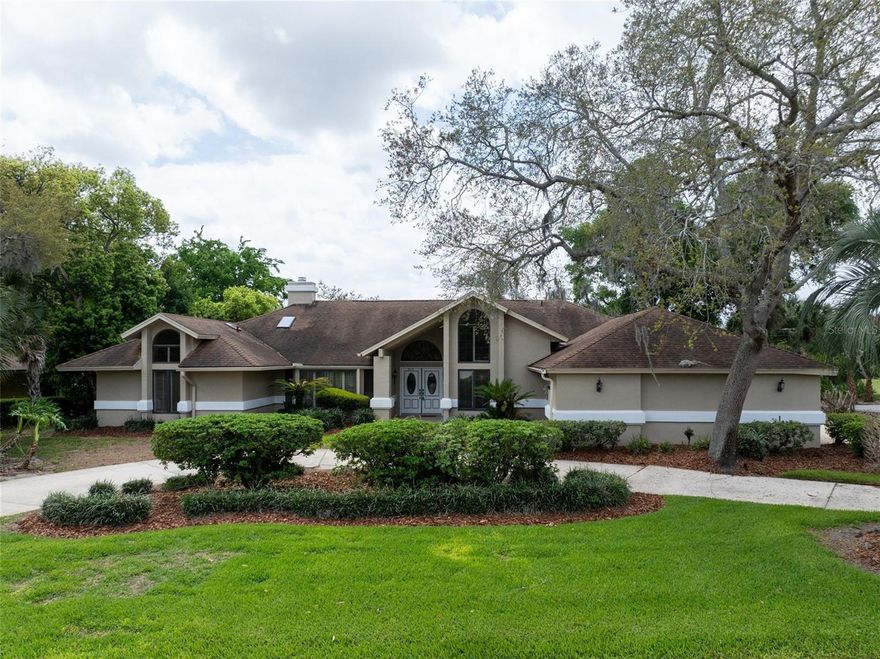 Golf Course Pool Home in Sugar Mill Country Club! This spacious 3-bedroom, 2.5-bath home with a  3-car garage offers 2,823 sq ft under air and sits directly on Hole 2 of the Red Course, which allows for peaceful golf course and pond views. Designed with a desirable split floor plan, this home features timeless classic charm throughout—ready for your personal touch. Step outside to your private oasis: a sparkling in-ground pool and spa beneath an oversized screened enclosure, complete with a covered patio—perfect for relaxing or entertaining while enjoying the serene views. Inside you will find two living areas, dining room, plantation shutters throughout, abundant storage and an interior laundry room with utility sink. Kitchen includes ample cabinetry and counter space, center prep island, walk-in pantry, additional built-in pantry, and wet bar. Oversized primary suite with golf course & Pond views, dual walk-in closets, and ensuite bath with double vanities, garden tub, walk-in shower, and built-in storage. Guest bedrooms are tucked away and share a full bath, both bedrooms have walk in closets; one offers direct pool access.  Additional highlights include: Quiet dead-end street (no through traffic), Circular driveway + extended driveway for ample parking, Guard-gated community for added security. Optional membership to Sugar Mill Country Club is available for golf, tennis, clubhouse, swimming pool, dining, fitness, and more.