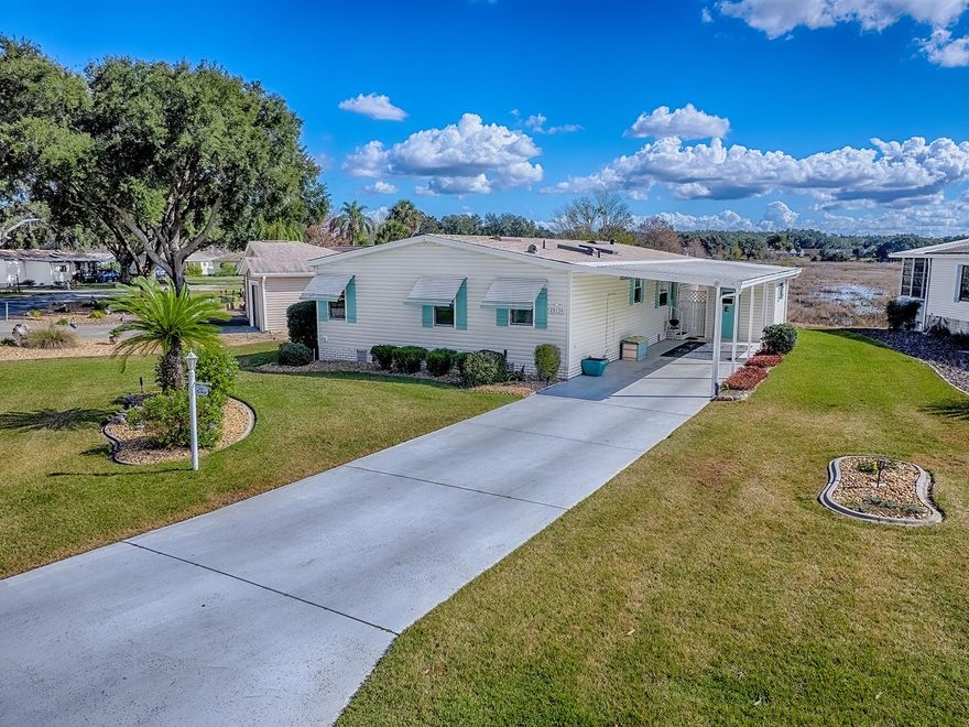 Welcome to this well-maintained and updated 2-bedroom, 2-bath home located on a large lot, on a quiet cul-de-sac with serene pond views in the desirable, guard-gated 55+ community of Plantation at Leesburg.  This charming residence offers an open, light-filled interior with spacious bedrooms and a comfortable, easy-living layout. The kitchen features ample cabinet space, a convenient breakfast bar, and newer appliances, making it ideal for both everyday living and entertaining. Sliding glass doors from the living room lead to the enclosed rear lanai, where you can relax and enjoy beautiful water views, sunsets, and birdwatching in a peaceful setting.  Additional highlights include a carport, a spacious interior laundry and office area, and recent major updates for peace of mind, including a new electric panel (2024) and a new roof and skylights (2024).  Residents of Plantation at Leesburg enjoy 24-hour guarded entry and an active, resort-style lifestyle with outstanding amenities, including two championship 18-hole golf courses, a driving range, three activity centers, three pools and spas, two fitness centers, tennis and pickleball courts, on-site restaurant and bar, billiards, arts and crafts, and numerous clubs and social activities. The golf-cart-friendly community also offers walking trails and a full calendar of planned events.  Conveniently located just minutes from downtown Leesburg, shopping, dining, medical facilities, lakes, and parks, and approximately one hour to Orlando attractions and under two hours to both Florida coasts. Experience comfort, security, and resort-style living in this move-in-ready home.