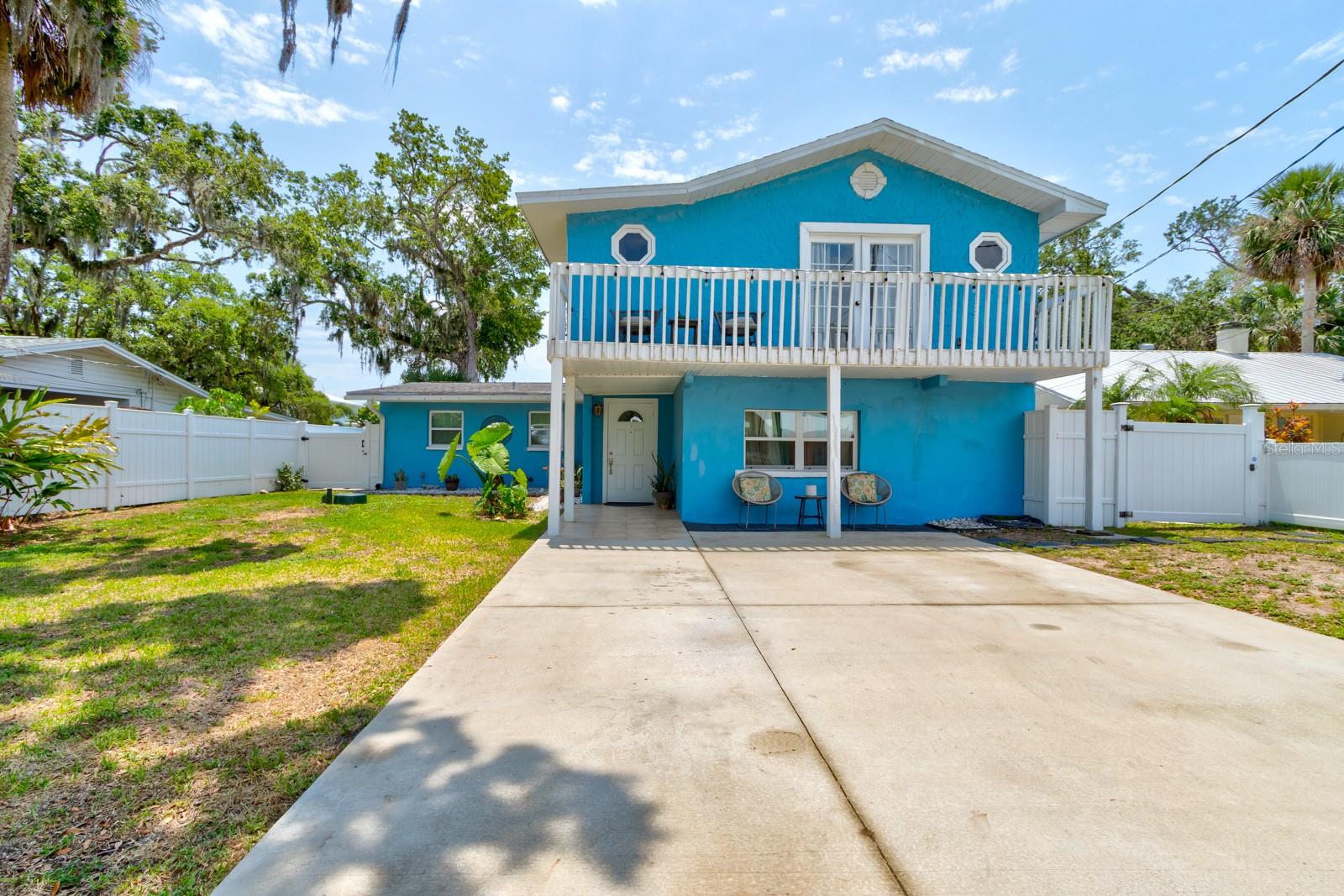 Your Waterfront Retreat Awaits at 184 Azalea Rd. Tucked just three homes in from the open river in the sought-after Waterway Park community, this vibrant 4-bedroom, 2-bath waterfront pool home delivers an immersive Florida lifestyle experience—indoors and out. Step inside to find expansive living areas with panoramic views of the sparkling screened-in pool and the lush canopy over and beyond the canal, evoking the feel of a peaceful Amazonian retreat. The downstairs layout includes three bedrooms, a large full bath, and an oversized laundry room with built-in shelving and space for a second fridge—perfect as a service pantry or prep zone. Upstairs, a private and expansive primary suite spans the entire level, featuring enough room for a king-size bed and additional seating or workspace. French doors open to a private balcony offering glimpses of the river, and tree-draped skies ideal for birdwatching, stargazing, or morning coffee. Outside, the screened pool offers year-round enjoyment, while the expansive dock—fully serviced and well-maintained—includes davit boat lift, two PWC davits, and an upper observation deck for catching river breezes night launches or watching meteor showers dance across the night sky. For Hurricane peace of mind~ No History of the river ever entering this home:) Additional perks include ample driveway parking, no HOA, and a quiet, paved street just minutes from shopping. Whether you're looking for a weekend getaway or a full-time waterfront home, this property checks all the boxes for serenity, space, and saltwater boating and jet ski access.