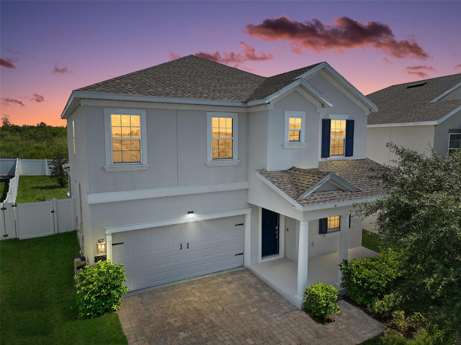 This elegant Groveland residence offers spacious living with four bedrooms and three bathrooms. Upon entry, the first floor welcomes you with a seamless tile flow through the kitchen, family room, and living room. The kitchen is a chef's delight, featuring quartz countertops, stainless steel appliances, and stylish pendant lighting. A convenient half bath is also located on this level.Ascend the stairs to find a thoughtful layout designed for comfort. The primary suite is a true retreat, boasting a large walk-in closet for ample storage. The second floor also includes three additional bedrooms, a full bathroom, and a second living room, providing flexible space for relaxation or entertainment. The upstairs is finished with plush carpeting in the living areas and bedrooms, while the bathrooms and laundry room are adorned with tile flooring. This home offers a perfect blend of style, comfort, and practicality for a well-rounded living experience.