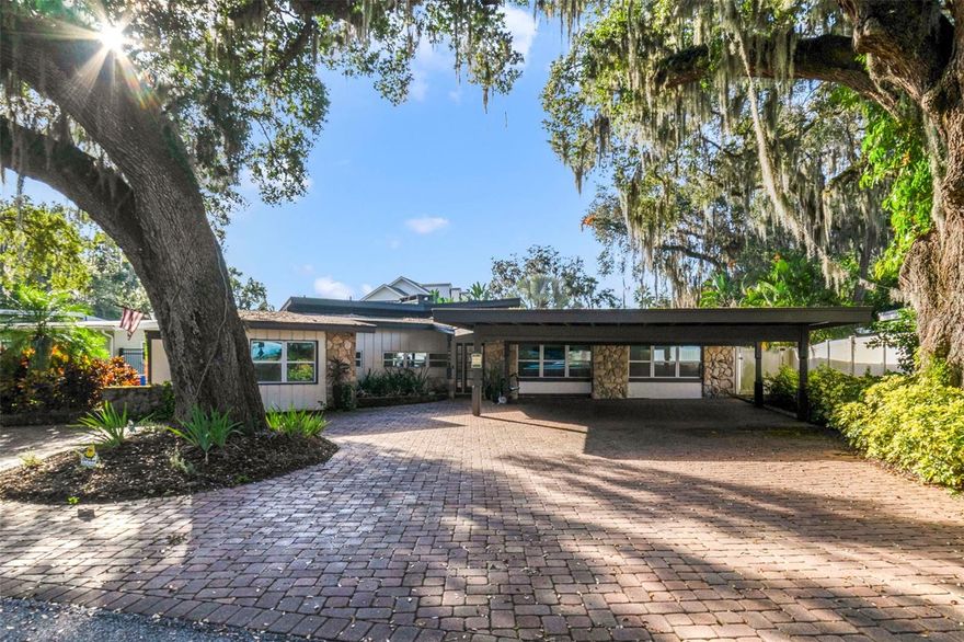 **Ask about a lender provided RATE BUY-DOWN CREDIT on this home!**A rare and remarkable opportunity awaits in Lakeside Village, where this over 2,700-SQUARE-FOOT single-story home delivers privacy, personality, and true Florida living at its finest. With 4 bedrooms and 3 full baths, a ONE-OF-A-KIND LAYOUT, and EXCLUSIVE DEEDED ACCESS to Lake Conway shared by just 22 homes, this residence offers a lifestyle few can claim. Step outside to your own TROPICAL-INSPIRED RETREAT, where a PRIVATE POOL—resurfaced in 2024—is surrounded by lush landscaping and a fully viny-fenced yard, perfect for entertaining or quiet relaxation. A paver driveway leads to a SPACIOUS CARPORT with ample room for BOAT PARKING, ideal for taking full advantage of lake living. Inside, the home opens to a GRAND LIVING SPACE adorned with MARBLE FLOORING, a decorative fireplace, and stylish ceiling fan, flowing beautifully into the Dining area and CHEF-INSPIRED Kitchen. The Dining space frames PEACEFUL BACKYARD VIEWS, while the stunning Kitchen is a true centerpiece, showcasing an abundance of cabinetry, MARBLE COUNTERTOPS, matching marble floors and sleek backsplash, and a built-in wine storage rack—perfect for entertaining in style. The Living area expands into a second OVERSIZED FAMILY ROOM, complete with dual ceiling fans and sliding glass doors that invite the outdoors in. The Primary Suite is nothing short of indulgent, featuring RICH WOOD FLOORING, a walk-in closet with custom storage, and a SPA-INSPIRED en suite bath. Here, you’ll unwind in luxury with dual vessel sinks, MARBLE COUNTERTOPS, a soaking garden tub, a walk-in shower with dual rain shower heads, and a private water closet. Adding incredible versatility, a SECOND PRIMARY SUITE with its own private entrance offers endless possibilities—ideal for guests, multigenerational living, or conversion to an ADU—complete with WARM WOOD FLOORING, a Murphy bed, sitting area, and private bath. Two additional bedrooms with wood flooring and a THIRD FULL BATH complete the home. RECENT UPGRADES including a TANKLESS WATER HEATER (2024) and PARTIAL REPLUMBING (2022) add comfort and peace of mind. PERFECTLY POSITIONED near Conway, Belle Isle, Downtown Orlando, and Orlando International Airport, with EASY ACCESS to SR 408 and I-4, this home blends convenience with exclusivity—where LAKE ACCESS, privacy, and RESORT-STYLE LIVING come together seamlessly. Homes like this rarely come to market—offering exclusive lake privileges, a tropical backyard retreat, and unmatched flexibility. This LAKESIDE VILLAGE GEM is more than a home; it’s a lifestyle. Schedule your showing today before it slips away!