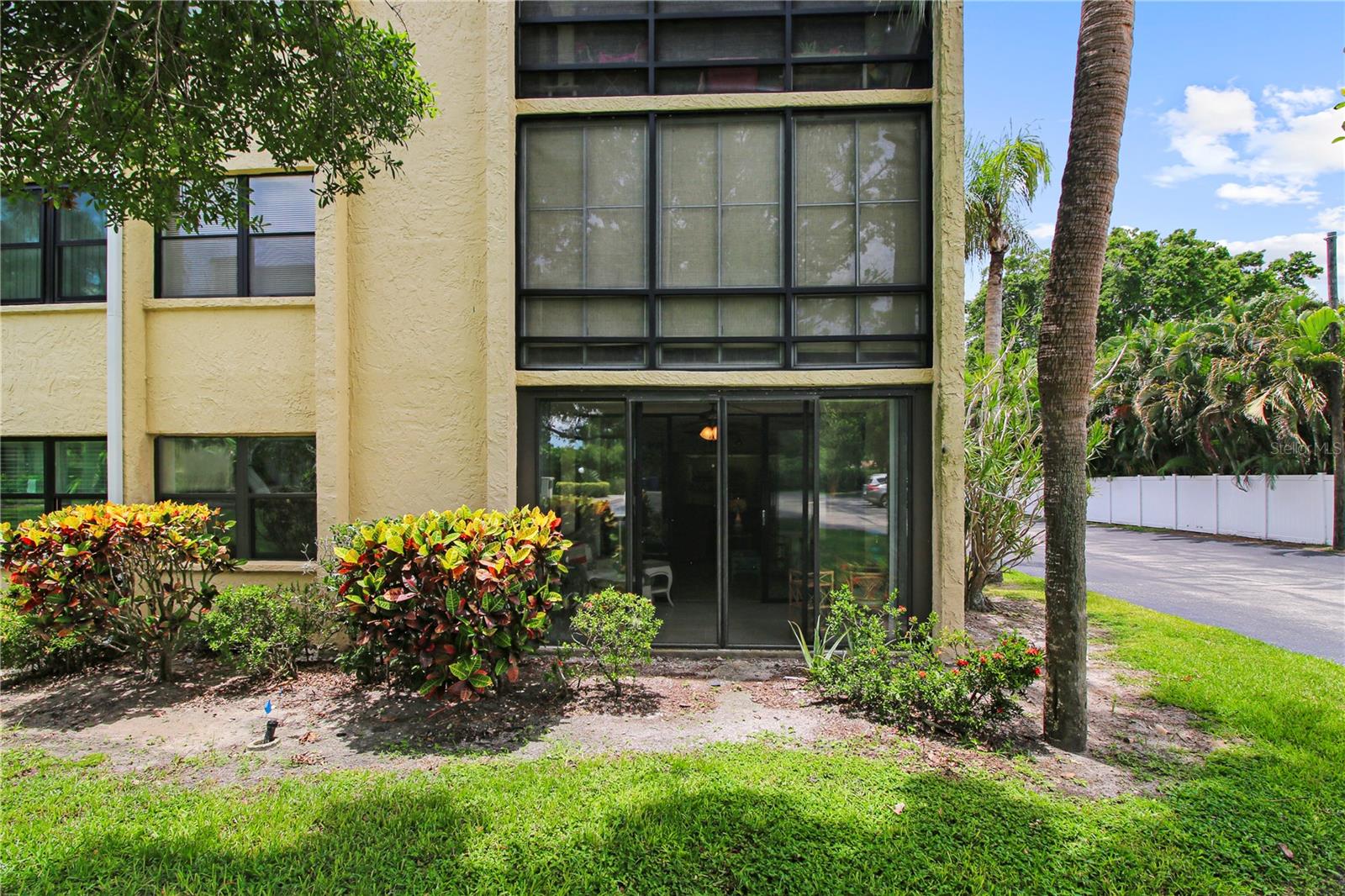 Convenient 1st floor End Unit! Spacious 2 bedroom, 2 bath with reasonable maintenance fees that include Cable, Internet, water, sewer, trash and exterior maintenance! Furnishings will be included if desired. Great layout with spacious primary bedroom and connected en-suite bath and walk-in closet, plus second bedroom with its own bath close by. Fully equipped kitchen, with newer stainless steel refrig. Large dining area and ample living room over-looking picturesque enclosed porch with sliders! Main living area, kitchen & dining and primary bedroom all have easy care updated large sized ceramic tiles in tasteful neutral tan color. Add your personal touches to make this your own. Owner will consider all reasonable offers. Submit your bid now!