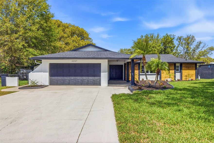 Move Right In!  This spacious LAKEFRONT home has been completely renovated and is ready for new owners!  This elegantly appointed home is located on an oversized waterfront lot in the highly sought-after Lake Padgett Estates.  Upon stepping into this home the first thing you will notice is the brand new designer kitchen complete with a MASSIVE granite waterfall island that also serves as a breakfast bar, as well as all new cabinets and appliances.  Brand new luxury vinyl flooring pours through the nearly 2,900 square feet of living space, with a spacious floor plan complete with 3 guest bedrooms.  The master bedrooms features a very roomy walk-in closet and the master bath has been completely redesigned, boasting a beautiful full walk-in shower complete with twin waterfall showerheads and adjacent standalone tub.  The home is nestled on a private lakefront with a very spacious backyard that includes a private patio complete with a private hot tub overlooking the lake.  In addition there are two large workshops on the property, perfect for the craftsman at heart.  The home also features a new roof on the main home as well as workshops and patio(2026), a new septic system, (2026), newer HVAC system, and a brand new irrigation system (2026).  Lake Padgett Estates offers Florida living at it's finest with three 180+ acre ski-sized lakes perfect for boating, fishing, and skiing, as well as community equestrian stables and plenty of recreation from the 5 lakefront parks, playgrounds, and tennis/basketball courts.  All of these features come while only being minutes away from I-75, affording you easy access to Wiregrass mall, The Outet Mall, The Groves, and plenty of fantastic shops and dining options.  This property has a repaired sinkhole with reports available, the remediation was done in 2026 and comes with a fully transferrable lifetime warranty.