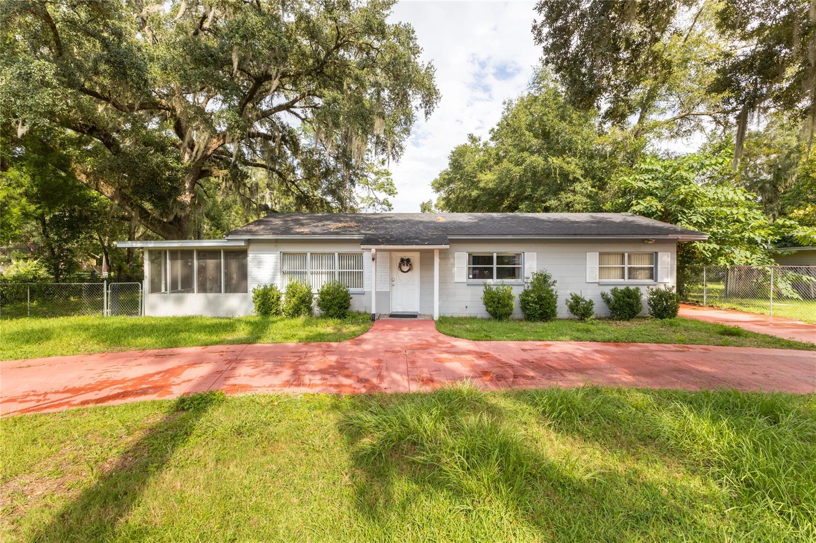One or more photo(s) has been virtually staged. Nestled in a quiet cul-de-sac, this charming 3-bedroom, 2-bath home offers tranquility and convenience. Enjoy easy access to Gainesville's
favorite spots and Alachua's San Felasco Tech City. The spacious backyard is perfect for year-round BBQs and gatherings with friends and family, while the circular driveway ensures ample parking for all your guests. Inside, the home features two separate living areas, providing space and comfort for everyone. A dedicated workroom and storage shed are the perfect space for your projects and keep your tools and toys safe and organized. Seller is offering $3000 for carpet allowance with acceptable offer.
