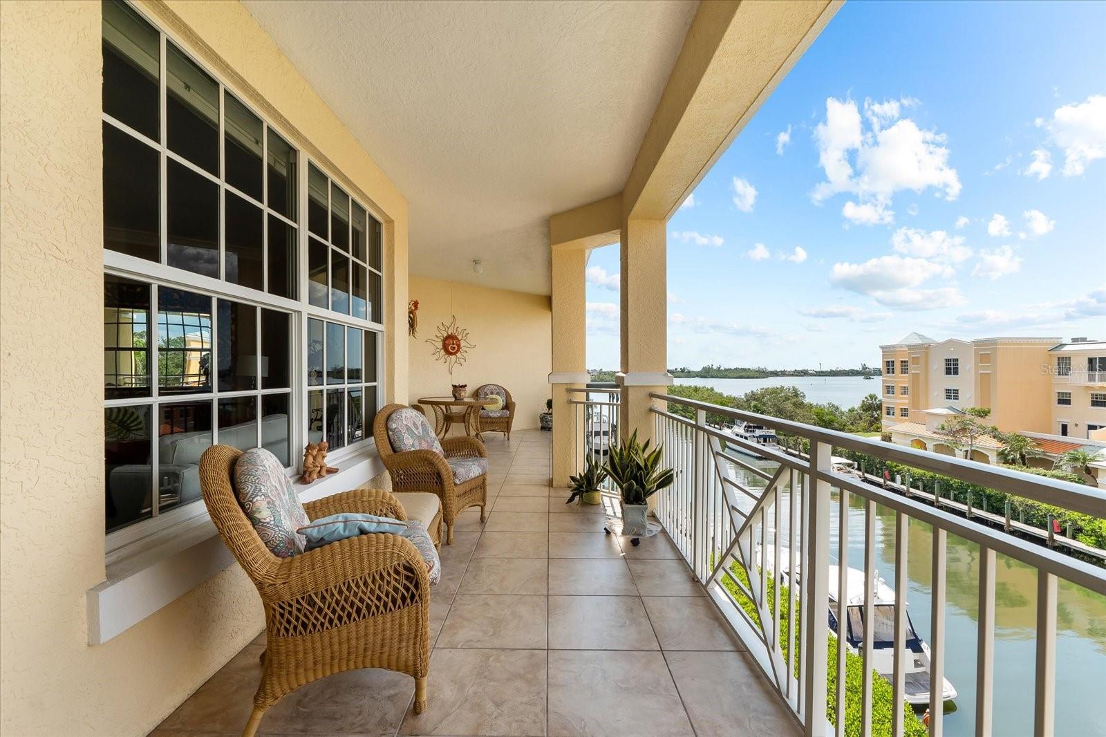 Luxury waterfront penthouse with deep water marina access. Discover Osprey Harbor Village, an exclusive gated condo community of only 53 residences perfectly positioned along Florida’s sparkling Intracoastal Waterway. This stunning 3 bedroom, 2 bath penthouse offers nearly 2,000 square feet of thoughtfully designed living space plus a generous 290 square foot tiled terrace with expansive views of the marina, the Intracoastal Waterway, and Sarasota Bay. From the moment you enter, you are welcomed by natural light, soaring 9.5 foot ceilings, and an open, flowing floor plan. Watch dolphins and manatees pass by, admire the rowers from your bedroom, and enjoy unforgettable sunsets from your private balcony every evening. This is the lifestyle you have been waiting for. The split bedroom layout offers privacy and function, while upscale finishes set this residence apart. Enjoy travertine and ceramic tile floors, crown molding, granite counters, solid wood cabinetry, and stainless appliances. The spacious primary suite features tranquil water views, a walk in shower, jetted spa tub, and large walk in closet. Additional highlights include two deeded indoor garage parking spaces, private storage, and impact rated windows throughout. The building was constructed to the highest hurricane standards, and a brand new metal roof was just installed. Osprey Harbor Village has never had storm damage or special assessments in its history, a true testament to the quality of construction and the care of this well managed community. The amenities are unmatched. Residents have access to a full service marina with wet and dry slips, a kayak launch, fishing dock, and bait and tackle shop right on site. Relax at the heated pool, soak in one of the two spas, or unwind in the sauna and steam rooms after a workout in the state of the art fitness center. Host a gathering in the stylish clubhouse with a full kitchen, TV lounge, and billiards table. There is secure indoor kayak and bike storage, a package delivery room, on site daily management, and controlled access for peace of mind. Located on the highly desirable Quiet Coast between Sarasota and Venice, Osprey Harbor Village is minutes from Siesta Key, Nokomis Beach, and the soft sands of Casey Key. Walk or bike to the Legacy Trail, enjoy nearby waterfront restaurants, golf courses, and boutique shopping. Whether you are a year round resident or seeking a luxurious seasonal retreat, this penthouse offers a rare opportunity to live above it all in one of Sarasota’s most exclusive waterfront communities. Make your appointment today and come see what life is like at the top. This is coastal living redefined.