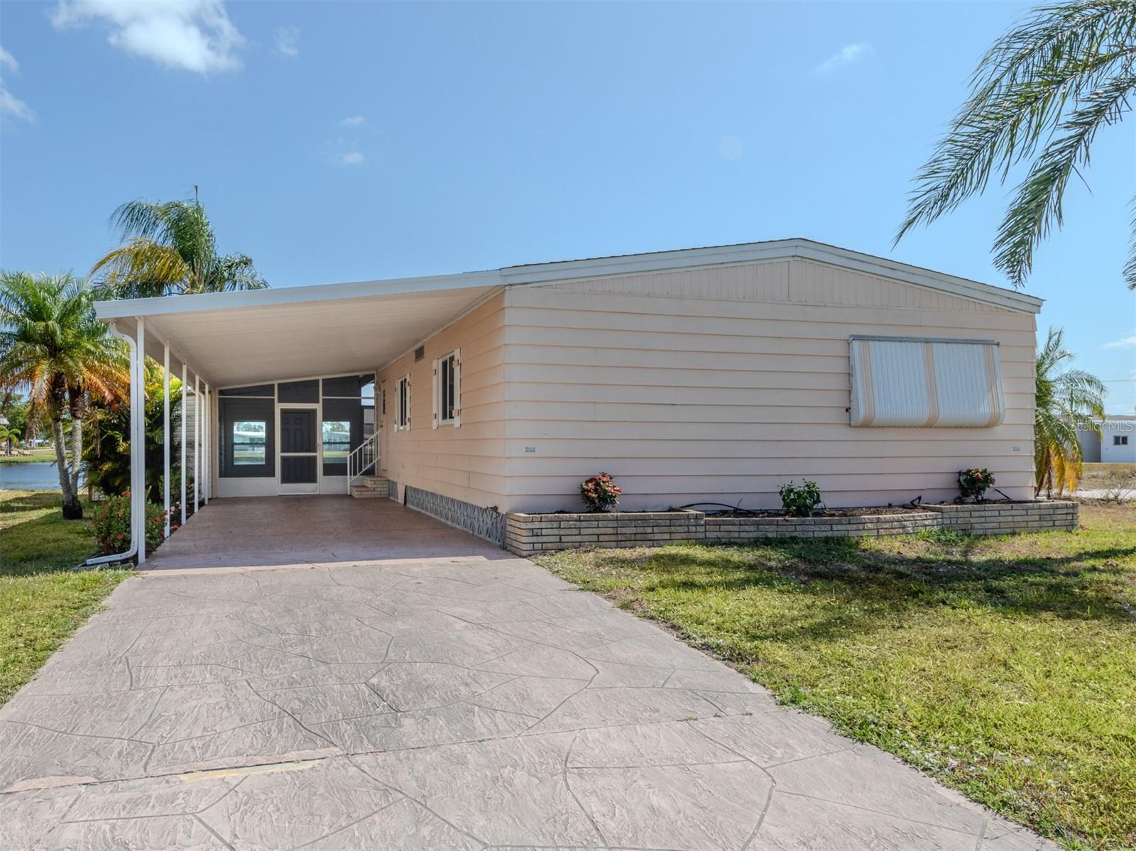 Adorable lakefront cottage is waiting for a new owner in the resort like community of Harbor Isles. Immaculate amenities and a myriad of activities year round. First come, first serve marina includes a kayak/canoe launch, fishing station, pavilion and boat slips. This home has an extra deep carport, an enclosed breezeway between the Florida room and utility room, brand new plywood sub floors and luxury vinyl throughout, freshly painted interior, updated windows, new electric panel 2024 and shingle roof 2023. The kitchen has newer appliances, counters and tile flooring. Both bedrooms have walk-in closets and bathrooms have replaced vanities and toilets. The Florida room adds an additional 247 square feet to the living area and has sweeping lake views that is the perfect space to relax with your morning coffee or afternoon libation. This home is ready for your personal touches and can be your slice of paradise! Convenient to the Atlanta Braves ball field, downtown Wellen Park, beaches, shopping, dining, library, churches, interstate, airports and more! Call today for your personal tour.