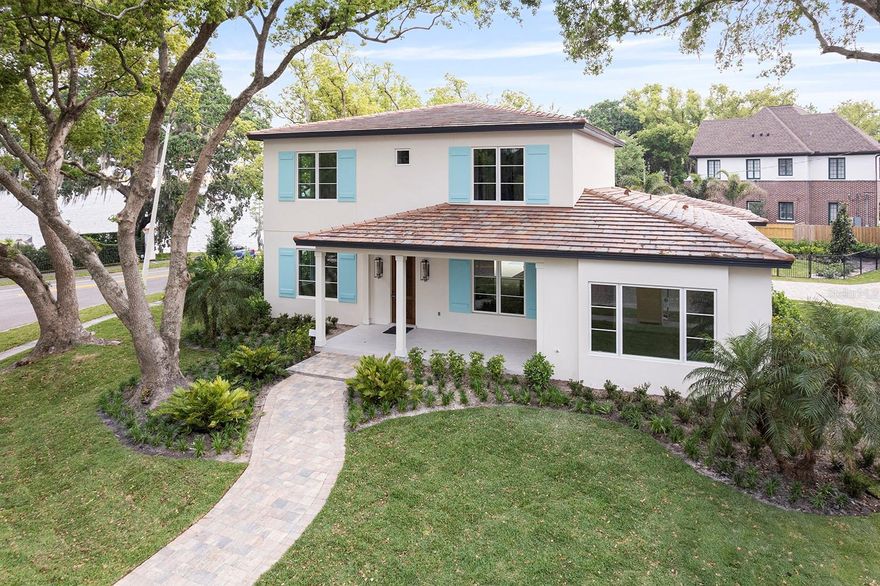 Welcome to a spectacular brand-new custom home nearing completion by the renowned Rex-Tibbs Development & Construction. Positioned on a beautifully landscaped corner lot, this elegant two-story residence offers picturesque views of Lake Adair, Lake Concord and iconic downtown Orlando skyline. With its timeless traditional design and classic tile roof, this home is a showcase of thoughtful craftsmanship and upscale finishes throughout. From the moment you step through the stately wood front door, you're welcomed into a smart and inviting floor plan designed for stylish entertaining and comfortable everyday living. The main level features a formal dining room and a gracious living room, flowing seamlessly into the heart of the home, an open chef’s kitchen outfitted with a generous island, a six-burner gas range, and premium Wolf/Sub-Zero appliances. The spacious family room is anchored by a sleek modern fireplace and a wall of sliding glass doors that open to an expansive covered lanai with a full summer kitchen—ideal for alfresco dining and effortless indoor-outdoor living. Step outside to your private oasis with a new pool overlooking Lake Concord, surrounded by lush landscaping and serene lake views. Upstairs, a generous bonus room offers spectacular views of downtown Orlando and surrounding lakes, along with three well-appointed bedrooms, each with its en-suite bath. Just steps from the heart of College Park’s charming Edgewater Drive, you’ll enjoy walkable access to boutique shopping, local eateries and coffee shops. Minutes away, explore the culture and energy of downtown Winter Park and downtown Orlando, including the Dr. Phillips Performing Arts Center, the Kia Center, Exploria Stadium and more. Convenient access to major roadways makes commuting to the Orlando International and Executive airports, area hospitals and Central Florida’s world-class attractions a breeze. Surrounded by scenic lakes and among other distinguished lakefront homes, this exquisite property offers an unmatched lifestyle in one of Orlando’s desirable neighborhoods.