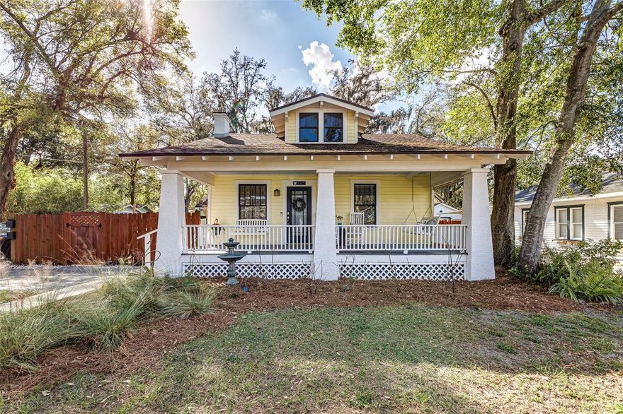This charming 3BR/3BA Craftsman-style bungalow sits on a quiet brick road between Lakes Hollingsworth and Morton, just minutes from Florida Southern College, Polk Museum of Art, Dixieland and Downtown Lakeland.

A welcoming front porch shaded by mature oak trees invites you inside to a light-filled, open-concept living, dining and kitchen space. Original weighted pulley windows, a classic fireplace mantel centerpiece, updated vinyl plank flooring, and crown molding throughout blend historic character with modern style. The kitchen features stainless-steel appliances, granite countertops, a stylish backsplash and a functional island with added storage.

The main home offers two bedrooms, a guest bath with distinctive tilework and a remodeled primary bath complete with double vanity and original clawfoot tub. A renovated mudroom that doubles as a laundry room with additional closet space leads to a fully fenced wrap around yard with lush Florida landscaping, firepit area and bistro lighting.

The detached historic carriage house studio includes a kitchenette, full bath, walk-in closet, loft storage and wood-beamed ceilings—perfect for guests, rental income or a home office.

Over the years, this home has been recognized for both its historic significance and thoughtful stewardship: 

• 2016 | Residential Preservation Award by Historic Lakeland, Inc
• 2022 | 18th Annual Historic Lake Morton Home and Garden Tour Stop
• 2023 | Lake Morton Century Home Inductee
• 2025 | Silver Level Florida Friendly Yard Designation