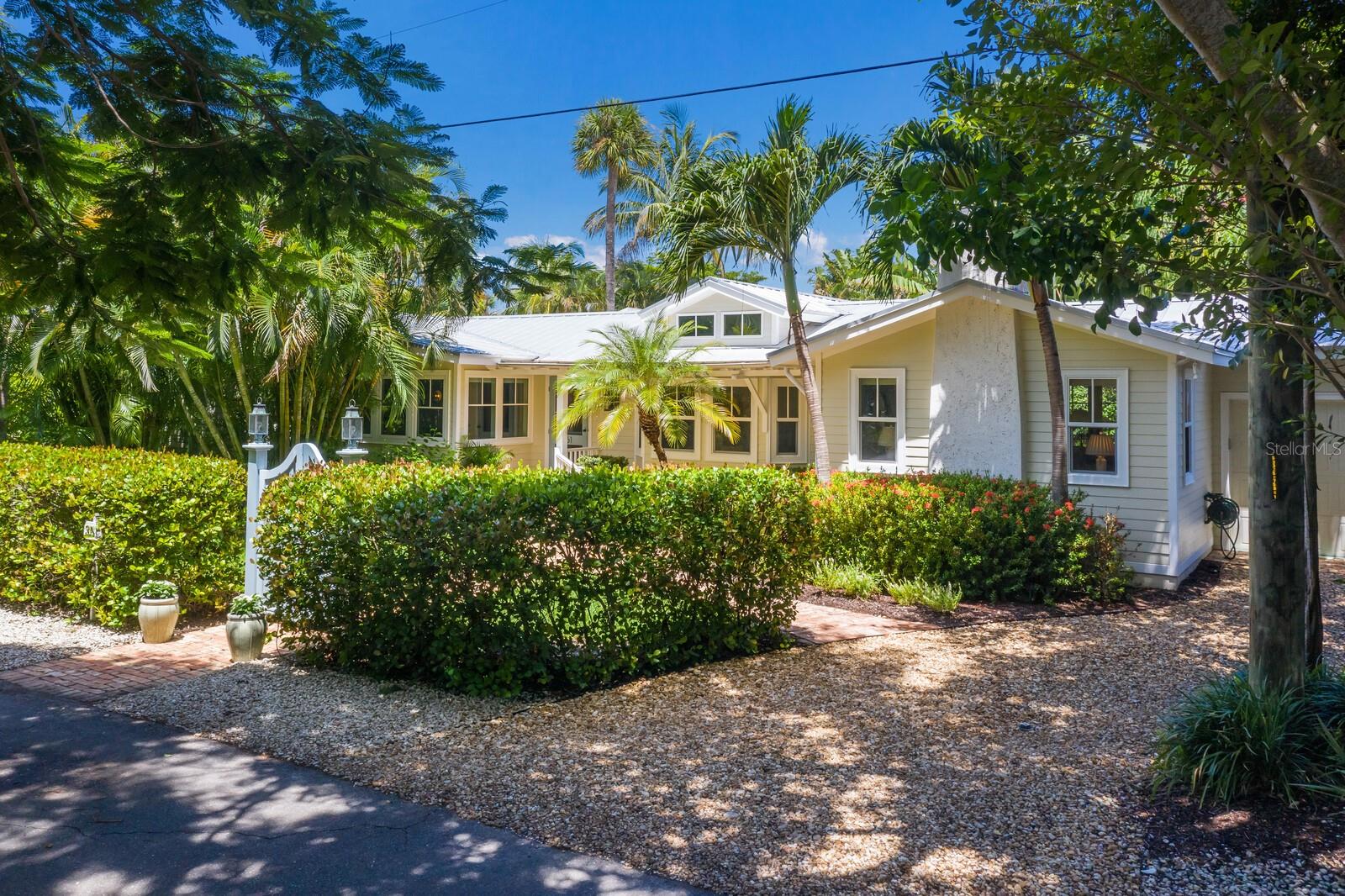 Rarely offered, this charming ground level “Tarpon Cottage” offers 2026 square feet of single level living in the heart of the Village of Boca Grande on the corner of Tarpon Avenue and 3rd Street. Originally built in 1910, this historically contributing cottage underwent a complete renovation in 2011, taking the structure down to the studs, and included new plumbing, wiring, impact glass, hardi-plank siding, and a new metal roof. The home offers hardwood flooring throughout as well as vaulted ceilings in the living room, dining room and primary bedroom. Three bedrooms and two and one-half baths provide ample space for family and entertaining, whilst maintaining its historical charm. Step outside of the living room french doors onto a private, fenced rear patio lined with Chicago brick and mature landscaping. The gated front entrance is flanked by mature hedges creating a private front yard great for sitting on a bench and enjoying tropical gulf breezes. There is a driveway on the east side of the home that has an enclosed golf cart garage and excess storage space, and the west side of the home offers uncovered off street parking as well. This is a great opportunity to live in a location that offers quick and easy access the village shops, restaurants and Gulf beaches.
Property is currently unfurnished. Pictures were taken before and after the removal of the furniture.