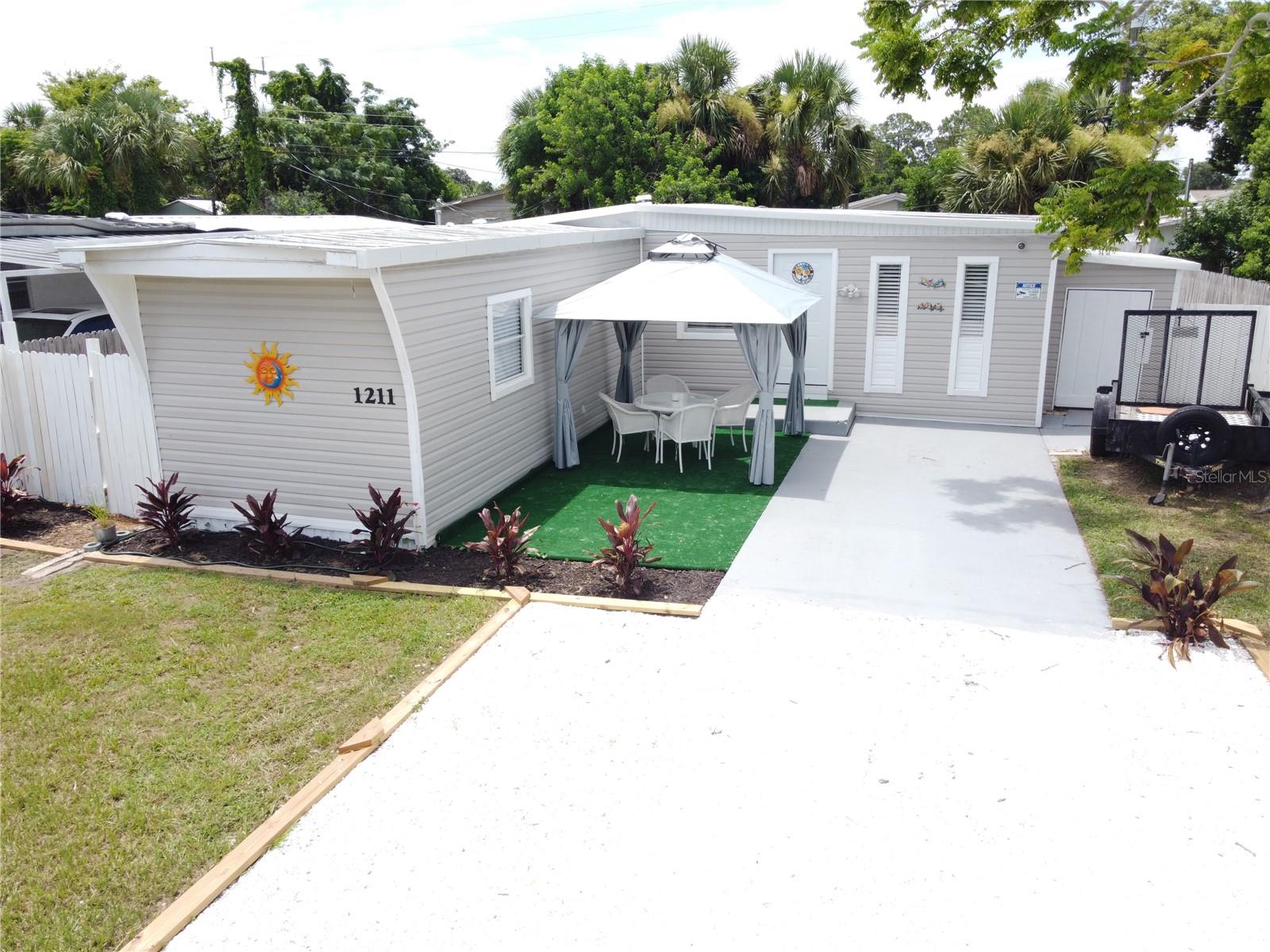 **OWN YOUR OWN LOT with DOUBLE WIDE MOBILE HOME**NO LOT RENT**OPTIONAL SELLER FINANCING with 50% down payment with Balloon Mortgage**REMODELED**3 Beds X 2 Baths + (2) Storage SHEDS with Electric Connections**FENCED BACKYARD**NEW KITCHEN with Stainless Steel GE PROFILE Appliances **NEW VINYL FLOORING with 5 ½ inch baseboards throughout**NEW CENTRAL AC unit**NEW HOT WATER HEATER**METAL ROOF has been SEALED with 2 coats of Modified Acrylic Sealant **NEWER WINDOWS**FRESHLY PAINTED INSIDE/OUT**Newer high end FRONT LOAD Washer & Dryer. In the heart of Port Orange, close to shopping centers, medical offices, Hospitals and 10 min to the beach. This lot is high and dry with plenty of parking, front deck area with Gazebo for family gatherings, and lots of landscaping front and back. All measurements are approximate but not guaranteed. HURRY UP...........Will Not Last Long.