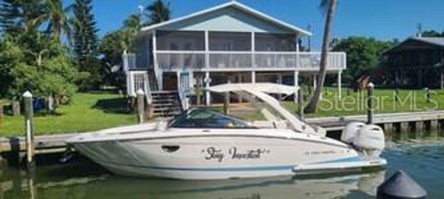 Waters Edge is offered as a turn key canal home on Little Gasparilla Island which is boat access only. This home is one of few on the island with 60 ft of private dock space in one of the only two canals. Home has open floor plan with water views from the kitchen, dining and living room. Screened upper deck is accessible by 3 french doors enlarging the space even more especially when entertaining. The bay front porch offers spectacular sunrise views. Downstairs deck area is great for relaxing with family, fishing off dock or cleaning your boat and simply living island life. There's a large outdoor shower that everyone enjoys after a day at the beach. Waters Edge is currently a VRBO rental with documented rental income and has many repeat vacationers. Other features include: standing seam roof, composite seawall, six year old Florida regulated septic, three year old A/C system, one year water heater and a minute walk to some of the most amazing sunsets you'll ever witness.
