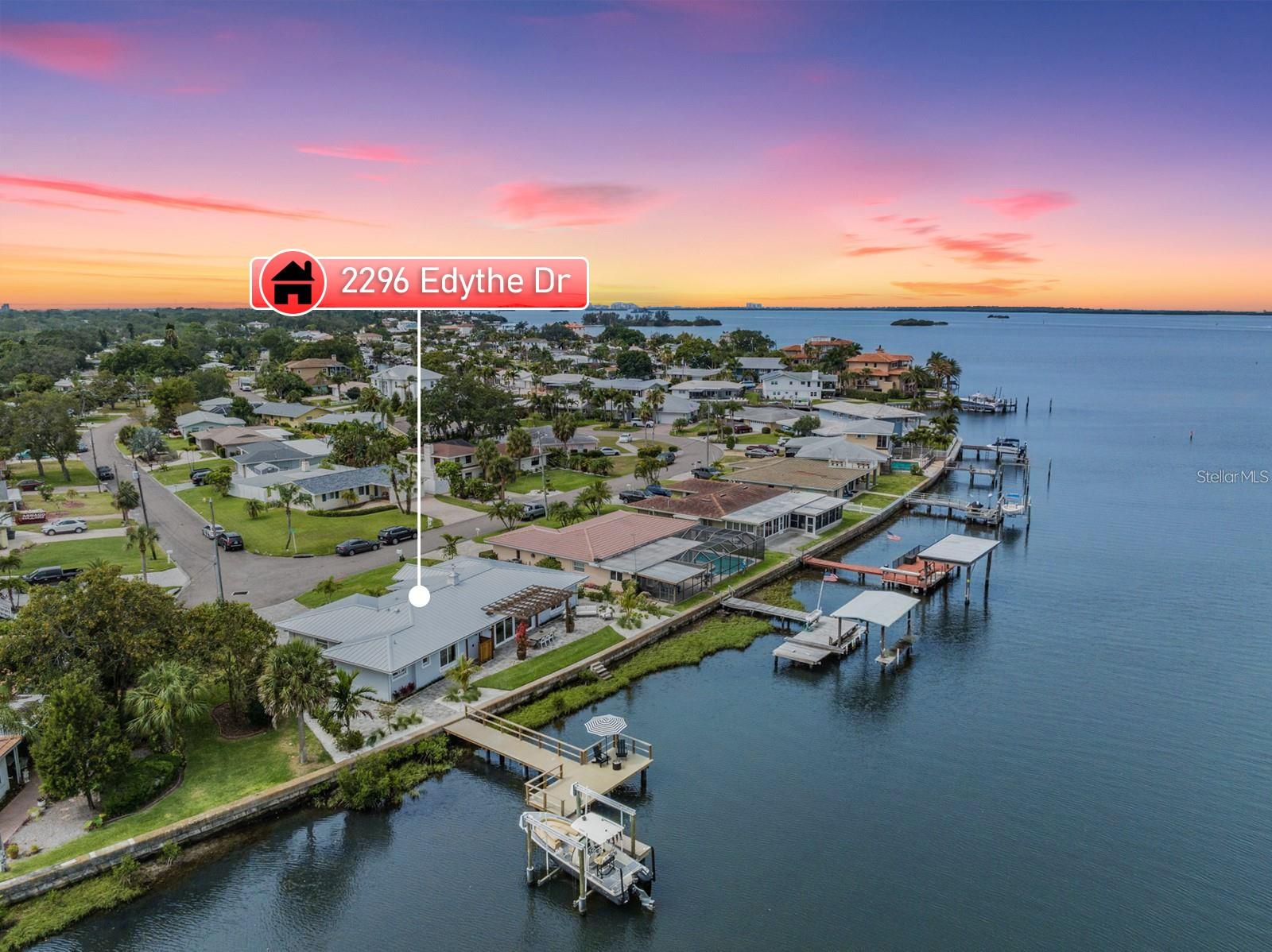 This STUNNING Waterfront Single Story Home in Delightful Dunedin is Being Offered for Sale by One of The Premier Design / Build Renovation Specialists in the Area. The 2350 sq. ft. Home Boasts Three Beautifully Designed Bedrooms, Two Luxurious Bathrooms, an Open Concept Living Space, Laundry Room, Outdoor Shower, Dock with 10,000 lb Boat Lift and Sunset Views. No Expense was Spared, as State-Of-The-Art Products were Used Throughout, Including Hand-Scraped Hardwood Oak Flooring, GE Monogram Gas Appliances, Built-in Miele Espresso and Coffee Station, Quartz Shelving, Smart-Home System, Designer Light Fixtures, a Brand New Metal Roof, and Natural Gas Service. The Extensive Woodwork and Imported Tiles Throughout the Home Exude Elegance and Sophistication. As You Enter the Home Through The Newly Added Entryway, Complete with Tongue and Groove Ceiling Inlay and Custom Lighting, You are Greeted with Sweeping Views of the Water Through the New Hurricane Impact Sliding Doors. The Dining Area Overlooks the Water, and Offers Beautiful Views of Sunsets and Wildlife. The Kitchen is Complete with Dove-Tail Custom Cabinetry, Quartz Countertops, Large Island with Seating, Custom Molding, Backlighting in Glass Cabinets, and is Finished With a Beautiful Custom Range Hood. The Split Floorplan Offers Complete Privacy For the Newly Added Primary Retreat, as Well as Views From Multiple Bedrooms. The Primary Retreat Is Complete with a Newly Added Large Walk-In Closet with Custom Built-In Shelving, Bathroom with Dual Sink Vanity, Private Water Closet and Large Shower with Soaking Tub. The Secondary Bedrooms Share a Bathroom with Dual Sinks, Soaking Tub and Walk-In Shower. Walking Outside Through the Sliding Doors, You are Greeted With a Beautiful Paver Patio, Trellis, Pathway to the Dock, as Well As Steps Right Into The Water. Plenty of Backyard Space to Add your Custom Designed Pool (see renderings in attachments). The Brand New Boat Lift and Dock Make it Easy to Enjoy All the Water Activities Florida Has to Offer. All of the Low Maintenance Florida Landscaping with Custom Up-Lighting Means More Time to Relax and Enjoy the Breathtaking Views and Everything Dunedin Has to Offer - The Pinellas Trail, Caladesi Island, Honeymoon Island, Art Festivals, Live Music, Hammock Park, Restaurants nearby, and Golf Carting. Don't Miss Out on the Chance to Own this One-Of-A-Kind Masterpiece.