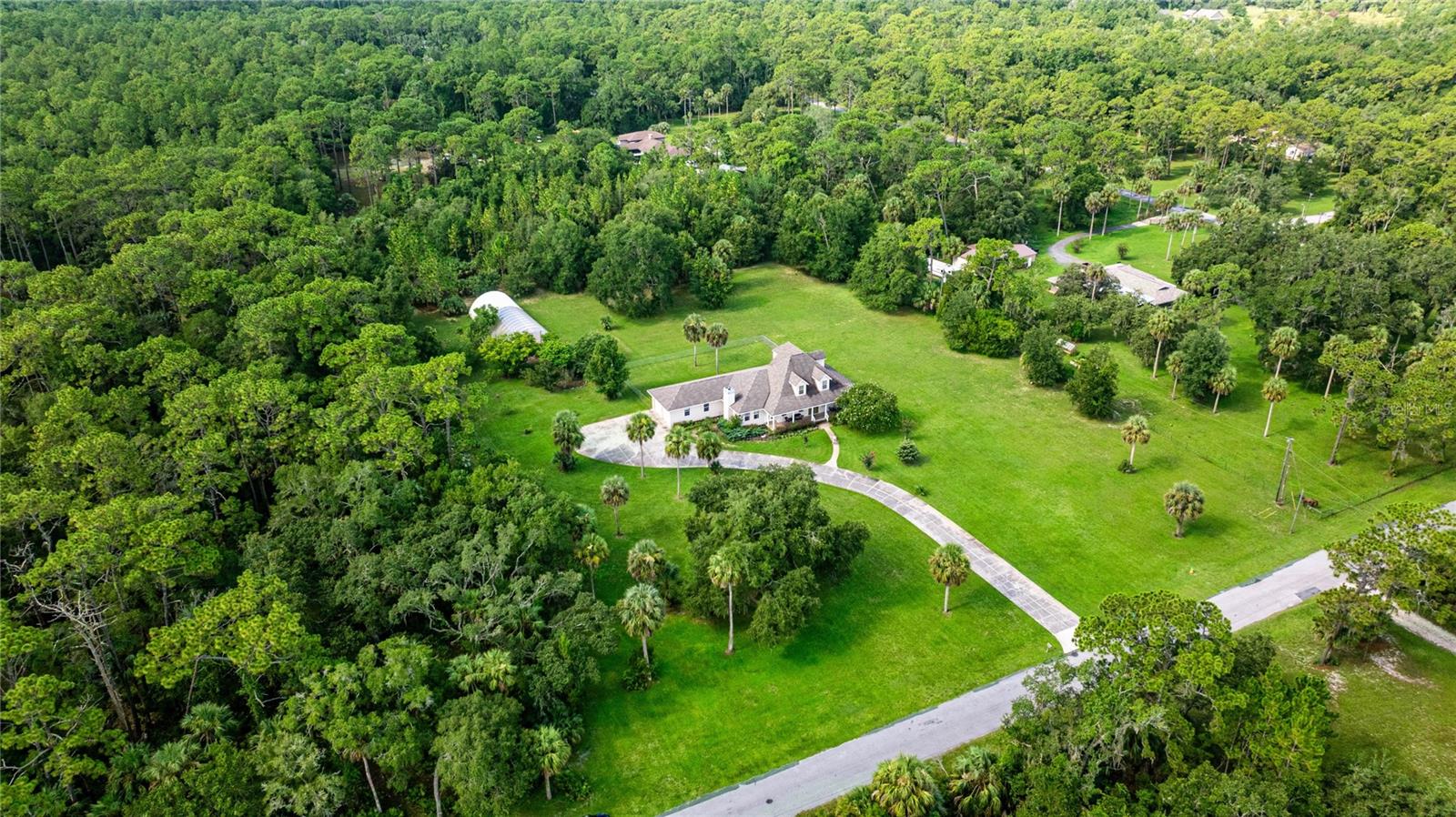 Welcome to your private oasis in Crystal River that has never flooded! This expansive two-story ranch home has 4 bedrooms, 4 bathrooms and sits on 4.85 acres of peace and privacy, offering space, charm, and versatility at every turn. Inside, you'll find gleaming hardwood floors throughout, a cozy woodburning fireplace, and a beautiful staircase that leads to a beautiful upper level. The main-level primary suite with walk-in closet is a true retreat, featuring a sitting area perfect for quiet mornings or winding down in the evening. The second bedroom is also on the main-level while the other two bedrooms are located upstairs giving everyone lots of personal space. The oversized home office a dream for remote work or creative pursuits, featuring lots of windows allowing all of the natural Florida sunshine in. With ample room for multiple desks or a cozy seating area, it's as functional as it is inspiring. The kitchen boasts a walk-in pantry, granite countertops, wood cabinets, pot rack, and opens into the heart of the home. It's a chef's dream and great for family gatherings. Upstairs, discover a large beautiful loft with abundant storage space-making it perfect for guests, growing family or for entertaining. The outdoor space is just as impressive, with two storage sheds and a massive 30' x 80' greenhouse-ready for serious gardening, hobbies, or celebrating a special event. The possibilities are endless. The expansive acreage provides privacy, space, and potential. Whether you're drawn to natural beauty, wildlife, local culture, or outdoor adventure, this home in Crystal River offers an ideal base to dive into everything this special region has to offer. Don't miss this rare opportunity- experience county living paired with nature's best, only minutes from downtown Crystal River, the gulf, famous springs, trails, and tranquil waterways. Conveniently located about 1-1/2 hours from Tampa and Orlando, and under an hour from Ocala making it easy for you to go see your loved ones or have your loved ones come see you. Schedule your private tour today!