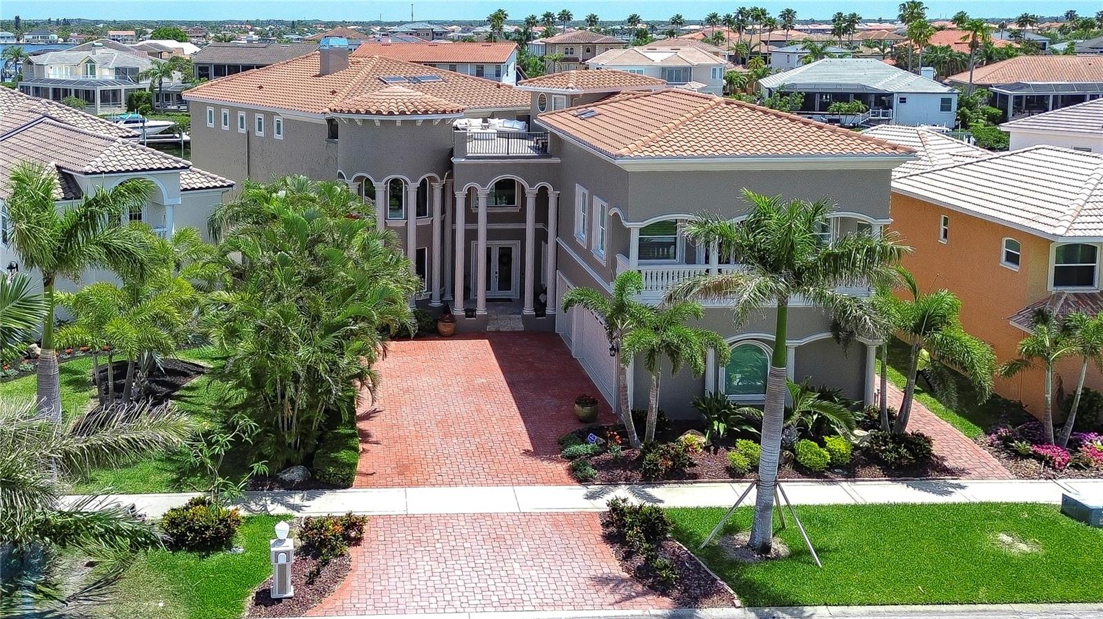 Welcome to paradise in the exclusive, gated waterfront community of Andalucia, where every day feels like a vacation. Perfectly positioned with sweeping Bayfront views and your own private dock, this stunning residence is truly one-of-a-kind. From the moment you arrive, the gorgeous elevation, elegant paver driveway, and lush landscaping make a memorable first impression. Inside, a spacious and flexible floor plan caters to your every need. Whether you're hosting lively gatherings, working from dual home offices, or accommodating guests with private first- or second-floor suites, this home offers the versatility and luxury to fit your lifestyle. Step into expansive living spaces filled with natural light and breathtaking views of the sparkling pool and oversized 27K pound boat lift, ready to accommodate a 40-foot boat with ease, and plenty of additional space for friends to dock their boats or add an additional floating dock. Travertine floors flow seamlessly throughout, adding to the home’s timeless sophistication. The open concept kitchen is a showstopper with upgraded cabinetry, gorgeous stone countertops, a built-in refrigerator, and a commercial-grade oversized range. The oversized island bar invites conversation and connection, making it the perfect spot to gather with friends and family. Retreat to the luxurious owner's suite, where you'll wake up to serene water views and enjoy a spa-like bath featuring a soaking tub, walk-in shower, and custom-built-in closets. Additional downstairs features include formal living and dining rooms, a guest suite, and a spacious office, plus an oversized garage for all your toys. But why stop there? Upstairs, you'll find even more to love—additional bedrooms, a large bonus room,a secondary office, and a private suite with a game room. The possibilities are endless: home theater, fitness studio, media lounge—you name it. And yes, there’s even a Romeo and Juliet balcony, the perfect perch to toast the sunset with a glass of wine and make unforgettable memories. This home also boasts a long list of updates, including a newer roof, updated pool, new AC units, replaced windows and sliders, and classic plantation shutters throughout. All this is nestled in Andalucia—an exclusive, waterfront community offering peace, privacy, and the perfect balance between tranquil coastal living and city convenience. Just a short drive to Tampa, Sarasota, and St. Pete, you’ll enjoy easy access to dining, shopping, and entertainment. Cruise out from your dock to explore the Bay or head over to Finn's dockside bar & grill or Circles for dinner on the water—it's all right here. Live the good life—on the water, in style, with everything you've dreamed of. Copy and paste this link to tour the home virtually: my.matterport.com/show/?m=zGP2NQmrQUG&mls=1