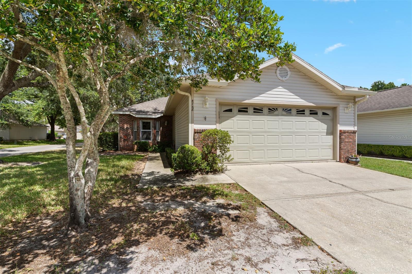 Maintenance-free living in Blues Creek! This beautiful, well-maintained corner lot home offers 1,545 sq. ft. of comfortable living space with an open floor plan. The kitchen features a picture window over the sink, a peninsula island with seating, and a spacious pantry, all overlooking the dining area and large living room. Just off the living room is a versatile office/den/bonus room with access to the backyard.
The primary suite includes a walk-in closet and private bath with a large vanity. Two additional bedrooms share a full bath with a tub/shower combo. The laundry closet, complete with washer and dryer, is conveniently located near the secondary bedrooms. Additional highlights include a two-car garage with pull-down attic storage, crown molding, mostly hard-surface flooring, and a newer roof (2018). Enjoy all that Blues Creek has with access to a community pool, tennis courts, and scenic walking trails, all set among quiet, tree-lined streets. Blues Creek is located just minutes from Publix, Fresh Market, Starbucks, and popular dining spots along NW 43rd Street and Millhopper Road. Plus, you’re only a short drive to the University of Florida, UF/Shands, and downtown Gainesville. The HOA fee covers exterior maintenance, lawn care, and access to the community pool and amenities, making this the perfect low-maintenance lifestyle!