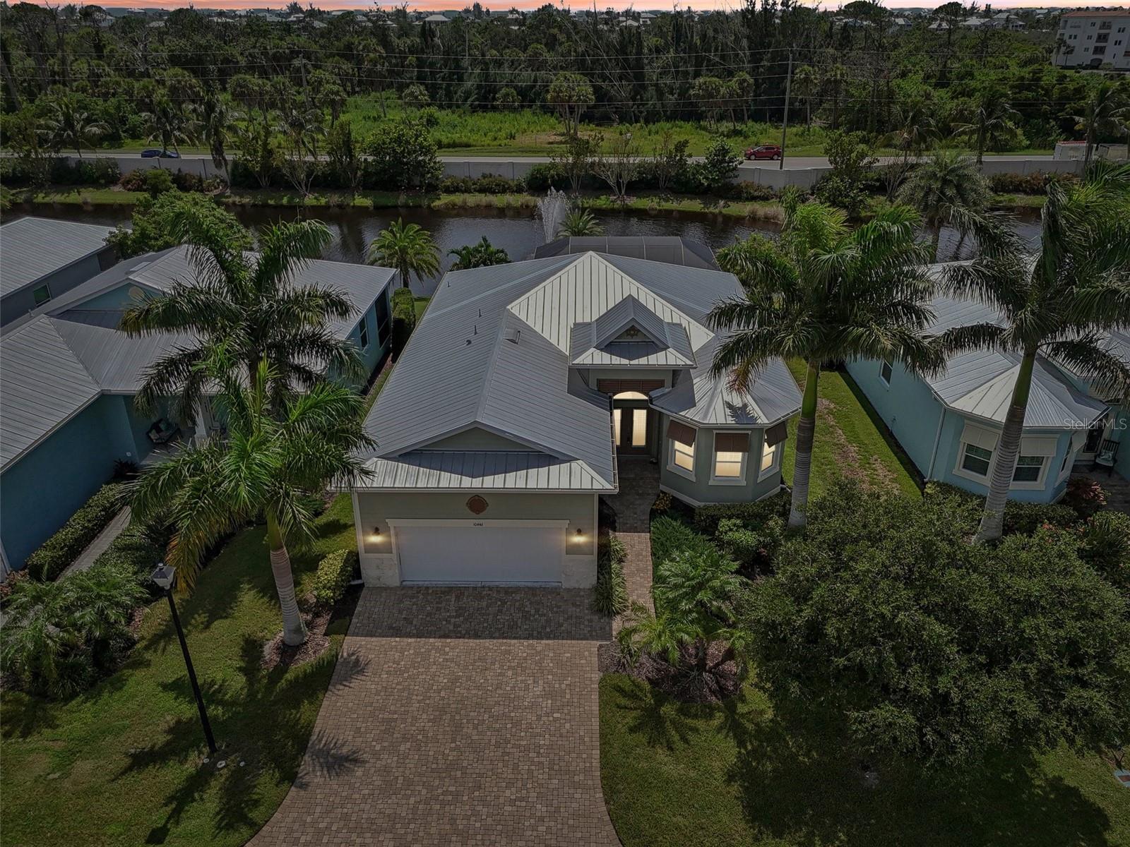 WHY SPEND THIS WINTER COLD??? Your slice of paradise is calling and your home is waiting! You will not want to miss this beautiful, FULLY FURNISHED home built in 2017 and nestled in the exclusive, gated community of Coral Caye. The community is comprised of 95 custom homes that were designed in the architectural style of the British West Indies. This impeccably maintained three bedroom, two bath waterfront home is loaded with custom details inside and out. As you enter the home you will be delighted by the easy to maintain porcelain tile which extends throughout the entire home. The open floor plan will lead you out to the lanai featuring a gorgeous Heated Pool that overlooks the fountain and pond. The kitchen abounds with custom details ranging from Natural Quartz Countertops, Stainless Appliances, and Closet Pantry. The spacious primary bedroom suite features walk in closets and dual vanity as well as a walk-in shower and soaking tub. The home has a Metal Roof and is built with a Stem wall foundation for added elevation. To add to your peace of mind, the doors and windows are all hurricane impact rated, with the door openings doubly protected by Storm Shutters. The garage is extended an additional four feet and the driveway is extra wide for all your Florida visitors. Come visit this private, gated, low maintenance community where your fees include lawn care, landscape maintenance and irrigation. Fees also include many residential amenities such as clubhouse use, pickleball courts, state of the art fitness center, screened outdoor gathering area, and pool. Friendly neighbors and social activities make this community a terrific place to live. Right outside the gate are miles of walking and biking paths. Coral Caye’s location cannot be beat, in the heart of Cape Haze, close to exclusive Boca Grande, miles of pristine beaches, numerous golf courses, the private Coral Creek Airport and THREE full-service marinas. Do not miss the opportunity to Enjoy the Florida lifestyle you have always dreamed of. This home is being offered turnkey, so just bring you suitcase and toothbrush to start enjoying your Florida Lifestyle.