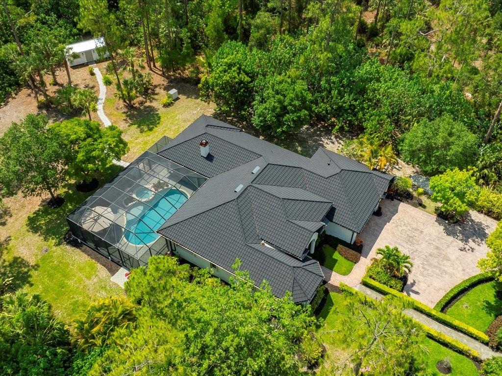 Additionally Upgraded, 5 bed plus Den / Dining, 3 bath 3,104 Sq Ft Gulfstream Sierra Preserve Model was previously upgraded in 2023 to reflect today's modern style. Since 2023, the Current Owners, whose plans have changed additionally added a Beautiful New Stone-Coated Metal Roof, Hurricane Protection System covering all windows and doors plus an upgraded up to date Security System. Sophisticated 2022 / 2023 improvements by the previous owner (an interior designer) included a complete kitchen remodel, cabinets, Quartzite countertops, Kitchen Aid, Bosch Induction cooktop & beverage bar with refrigerator. The opulent master bath received luxury spa features with new plumbing, flooring, cabinets, soaking tub & a glassed-in shower. A long paver solar-lit driveway via Electric Gates leads you through the private 2.27-acre park like setting. The manicured lawn and grounds have a variety of plants and trees (tree and plant list is available within the features sheet), with a Zen-like oasis courtyard for seating. Features include whole house Reverse Osmosis system, sprinkler system, an XL detached storage unit / man cave / she shed / kid's playroom. The second master has In-Law suite possibilities; it is currently set up as a games room. There are lavish tray ceilings with crown molding throughout. This Private Oasis showcases Florida living at its finest with 1200 Sq Ft of paved deck around the heated saltwater pool & spa. This desirable estate property is located close in, shopping is only a few minutes away, yet you have the resort feeling with privacy and space. Many buyers missed out last time when this hard to find gem was previously listed in 2023; please don't be one of those who misses out this time. Floor plan, features sheet, survey and Roof / Hurricane Protection (receipts totaling $120,000+) are available. Furniture is Negotiable with Exclusions (list available). Bring your offer today. Address for GPS is 2360 19th St SW, Naples FL, 34117. There is a yard sign to help locate. HT265